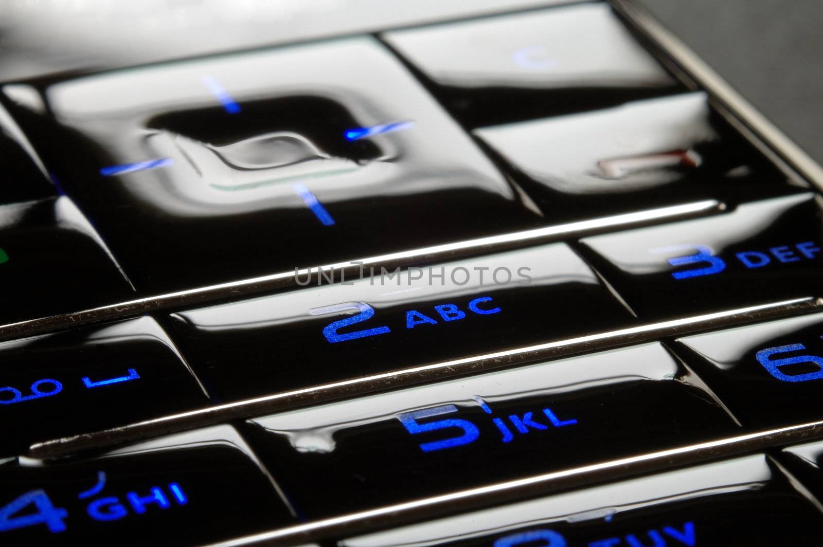 Close up shot of blue mobile keypad under dark environment
