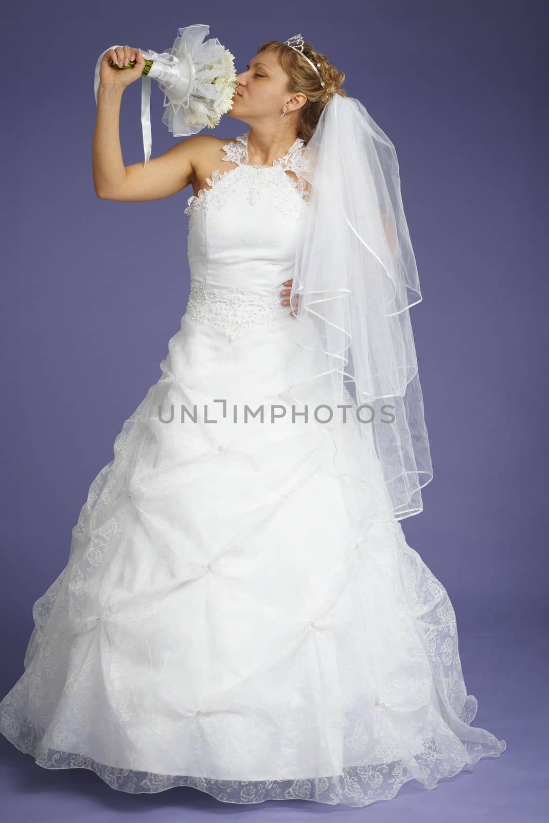 The bride with a bouquet on a blue background