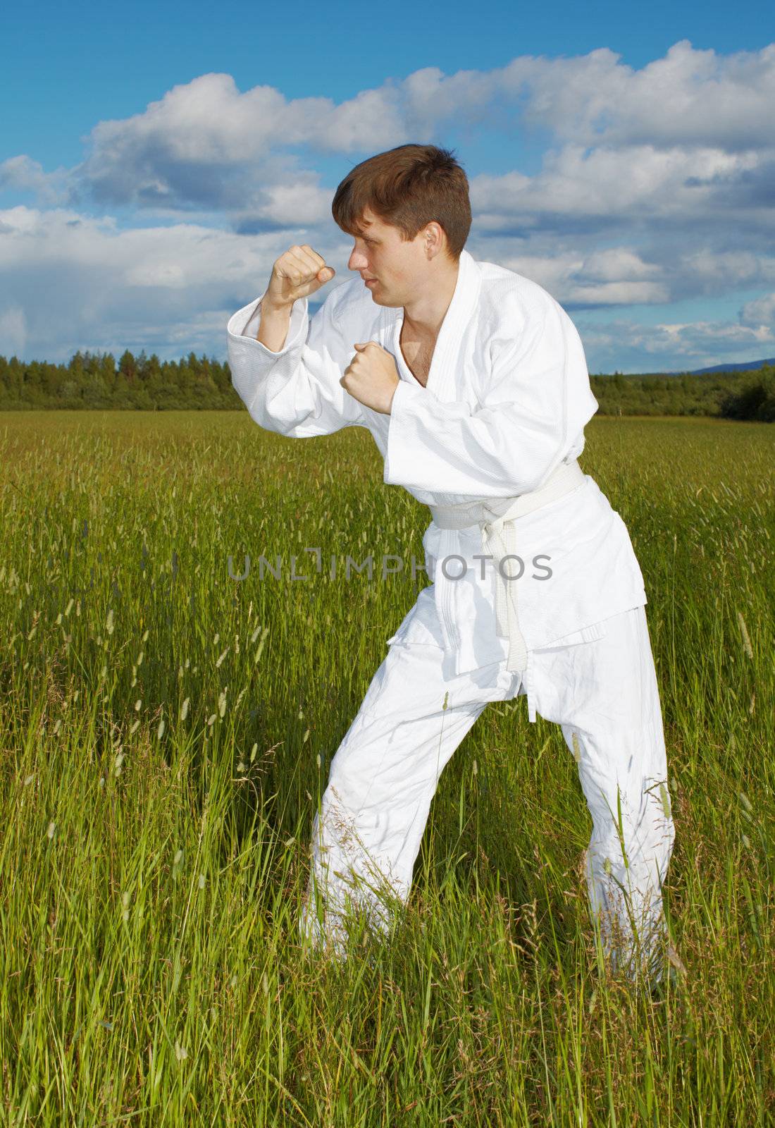 Young people engaged in martial arts outdoors