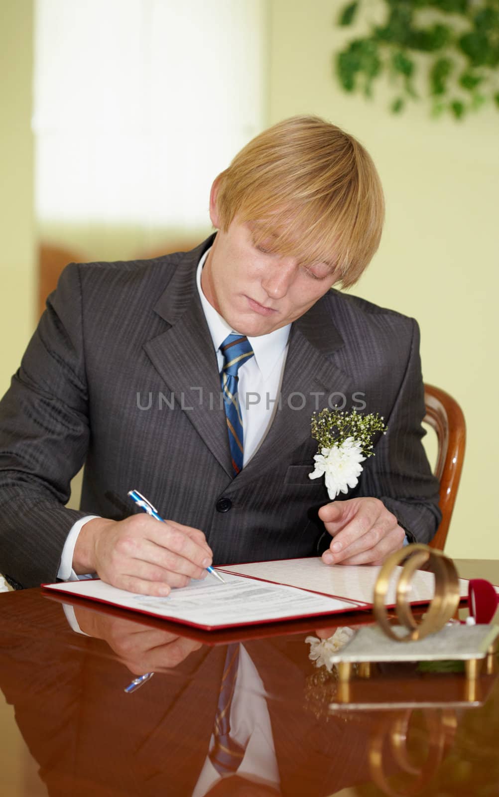 The groom solemnly signed wedding documents