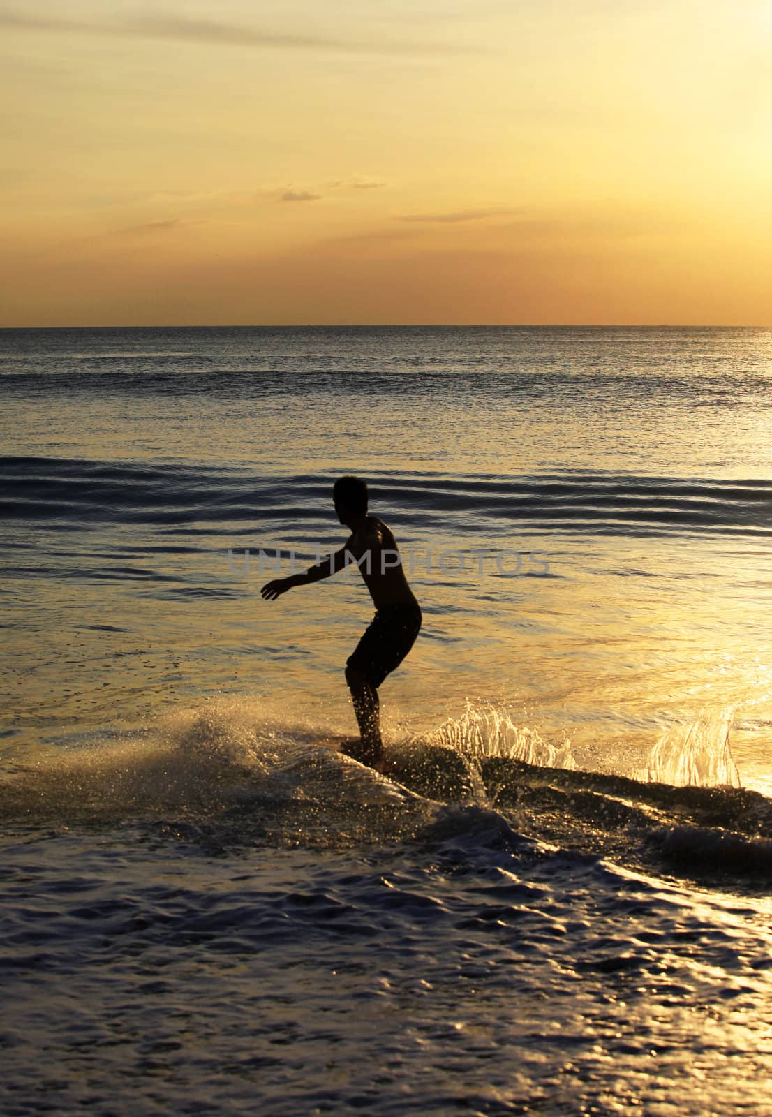 Young men - the surfer in ocean. Bali. Indonesia