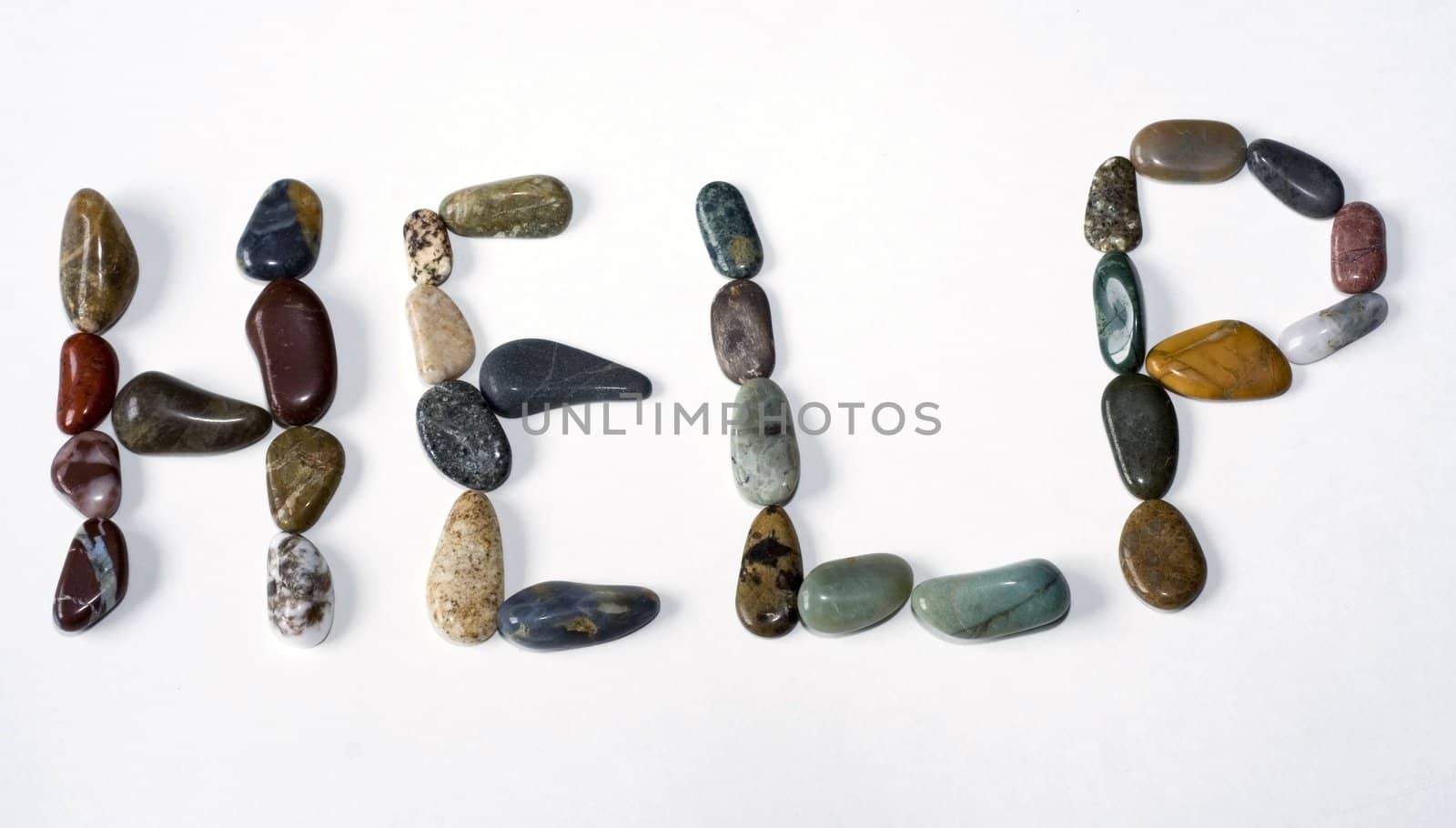 The word help spelled out in colorful polished gems and stones on a white background