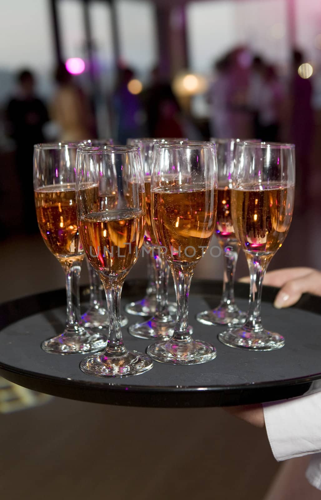 waitress serving champagne glass. Party by elenarostunova