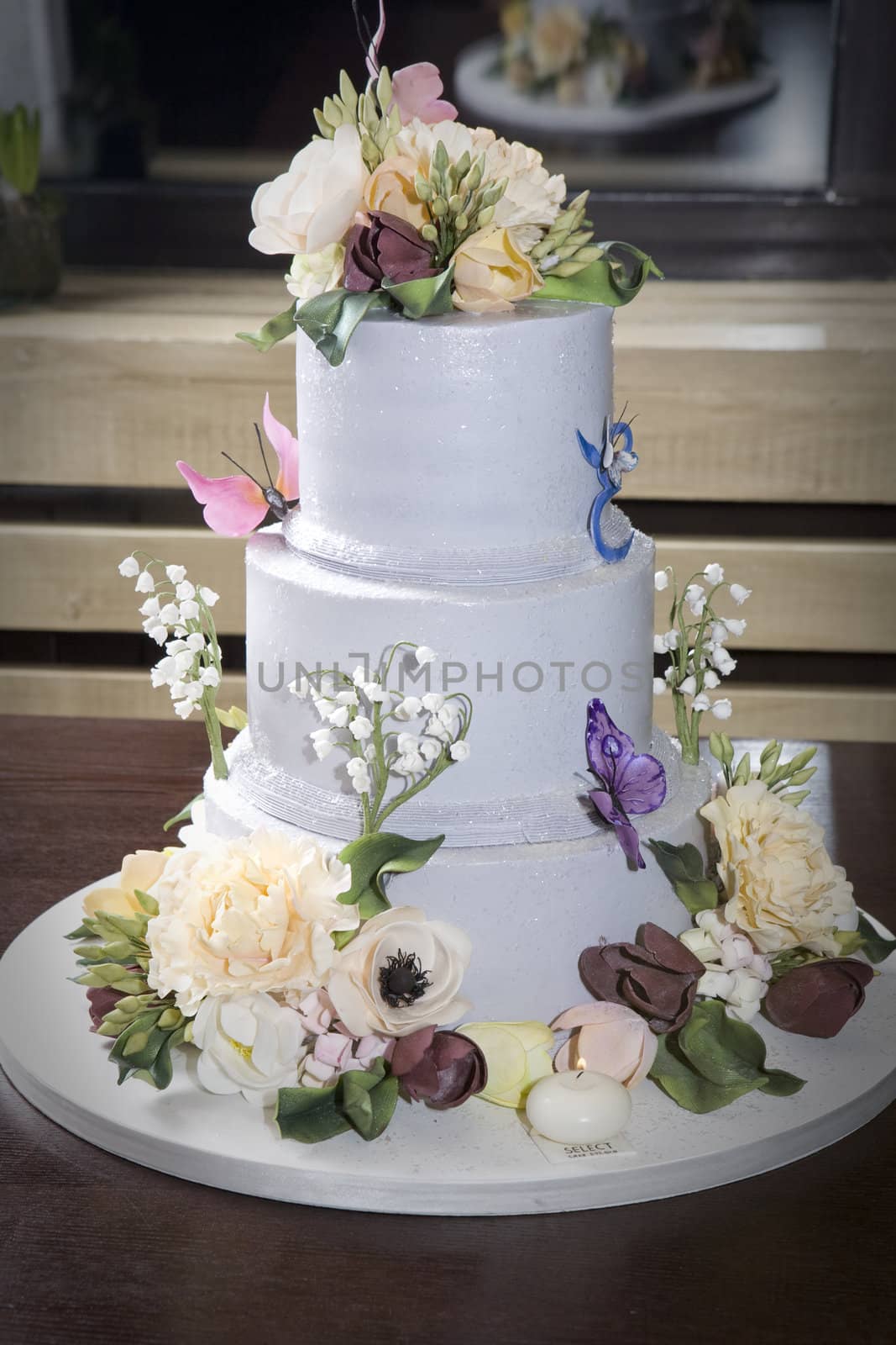 birthday cake with flower and butterfly on table