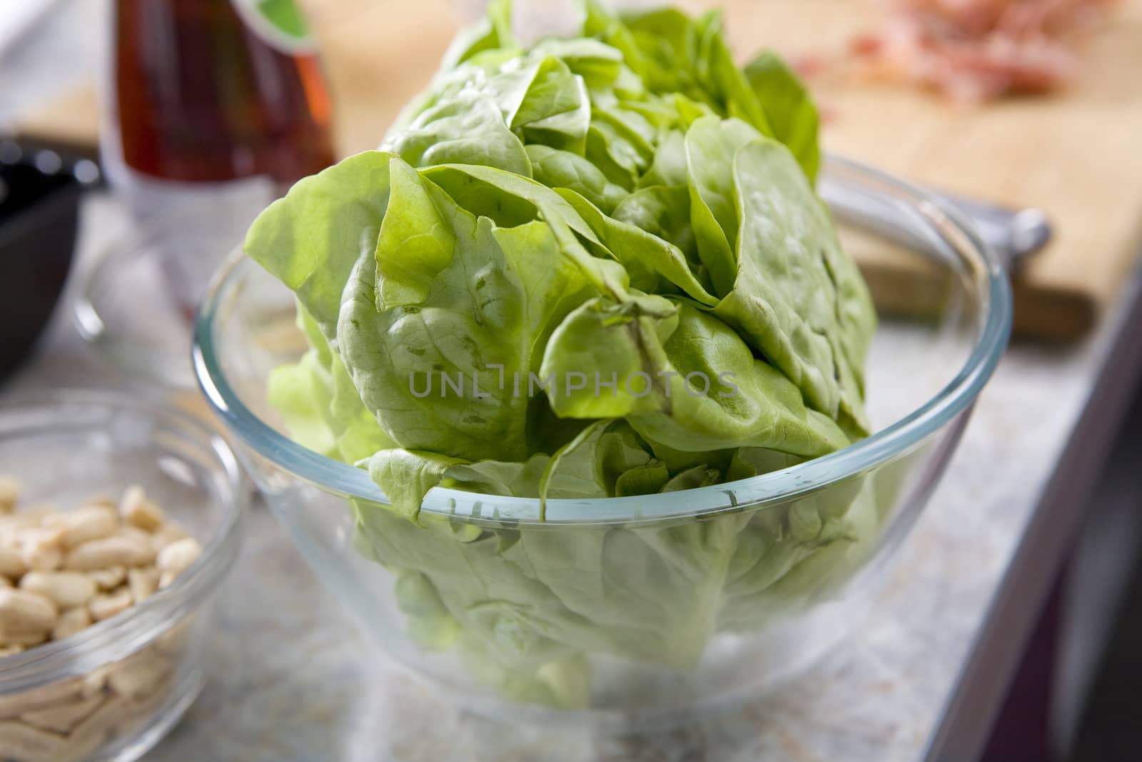 Green salad in a bowl on table before cooking