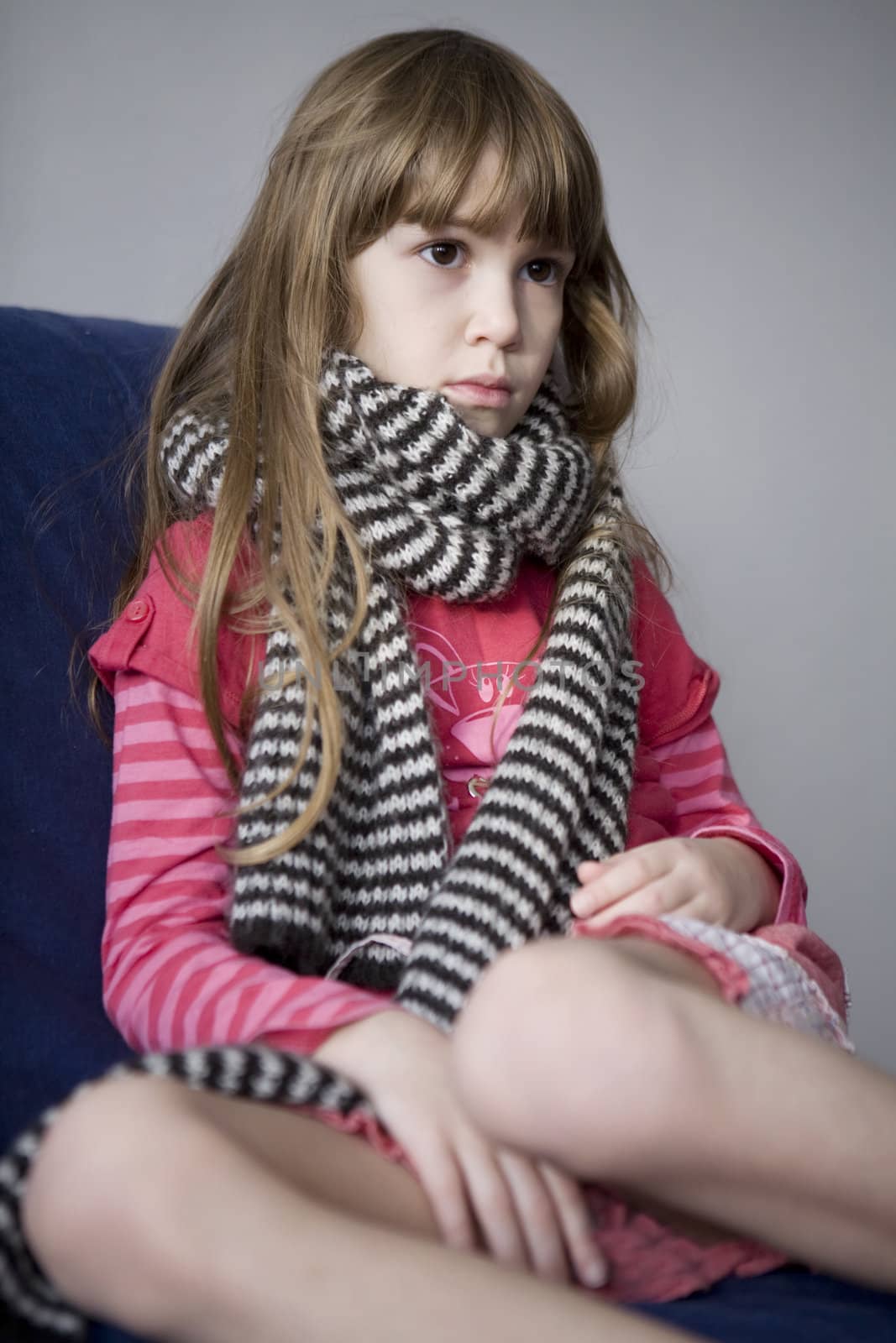 Llittle cute sick girl with scarf. Sore throat