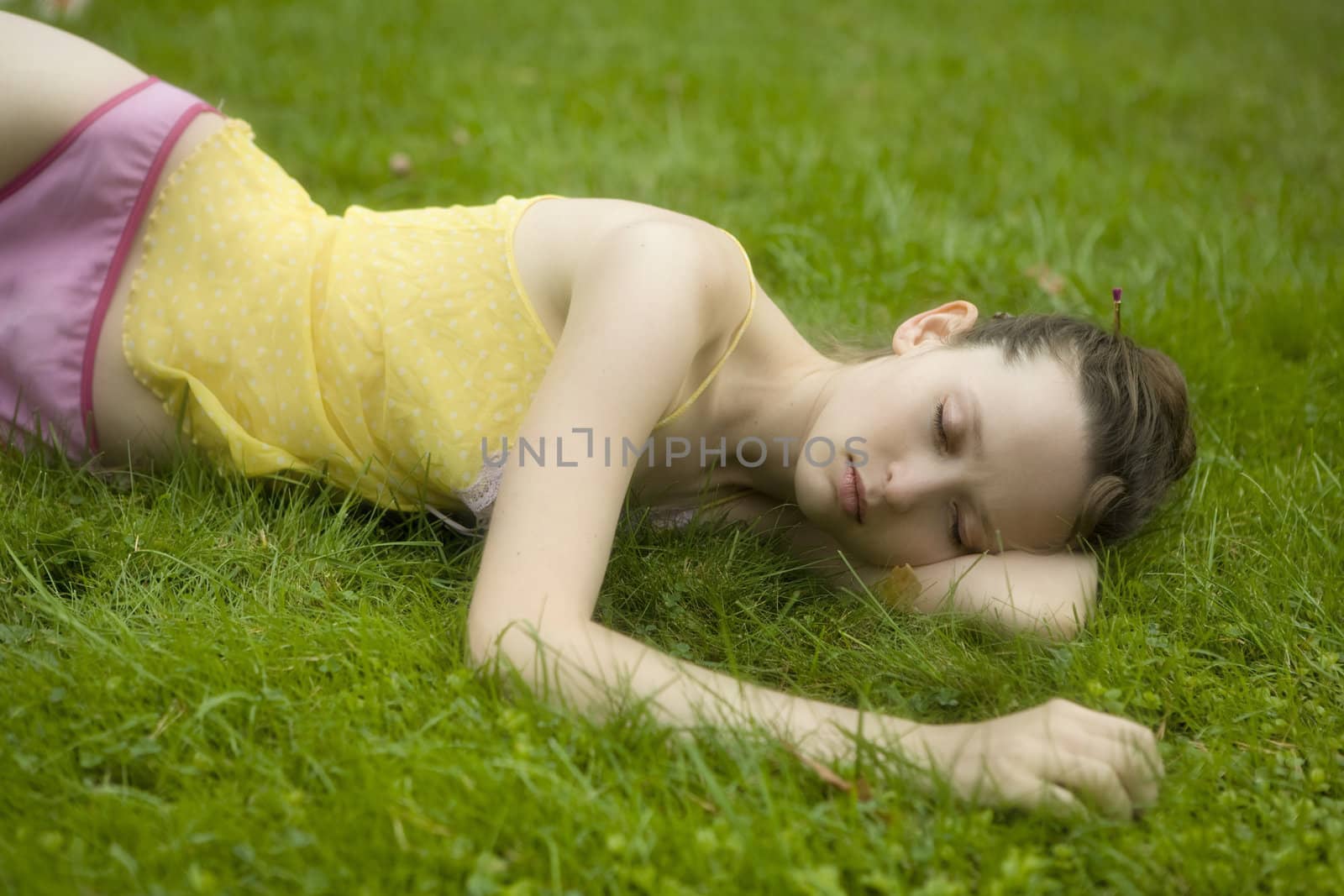 Young woman  lying  in summer park by elenarostunova