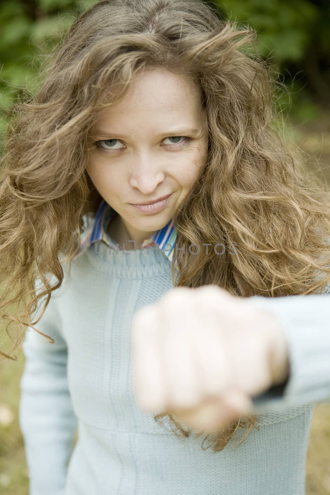 Portrait of an attractive young aggressive female punching by elenarostunova