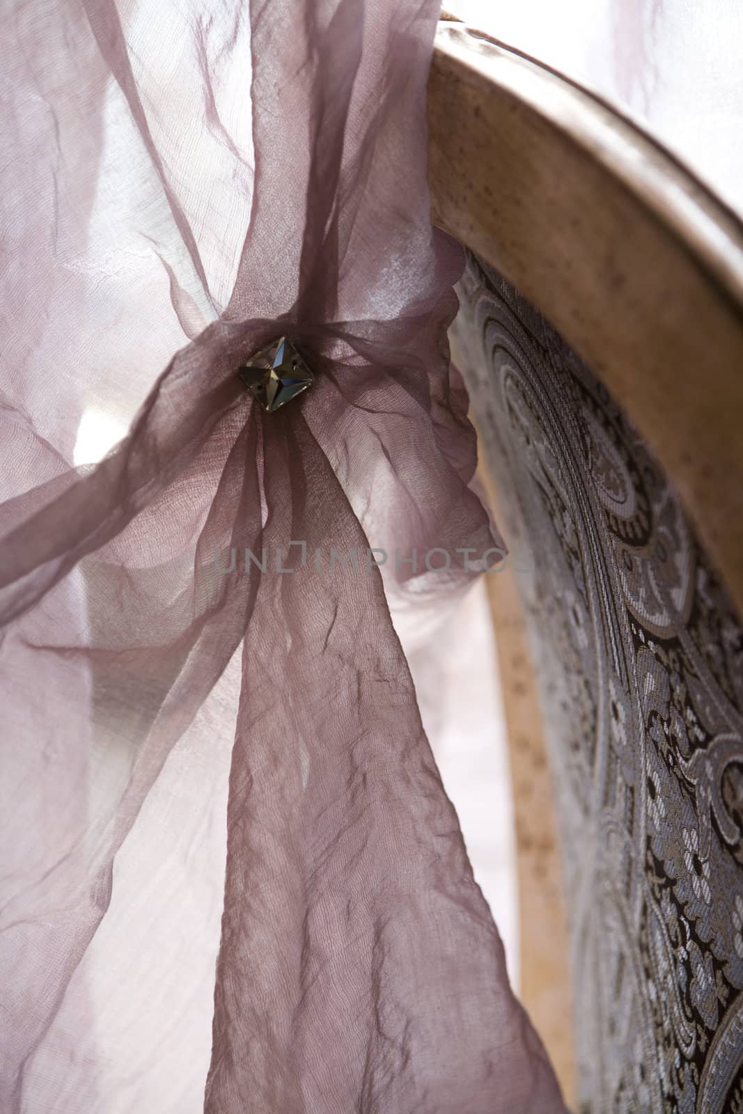 Luxurious lilac  curtain with brooch and back of chair by elenarostunova