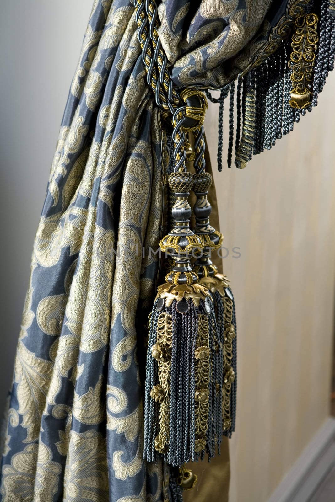 Luxurious curtain from woollen cloth with tassel. Blue and gold by elenarostunova