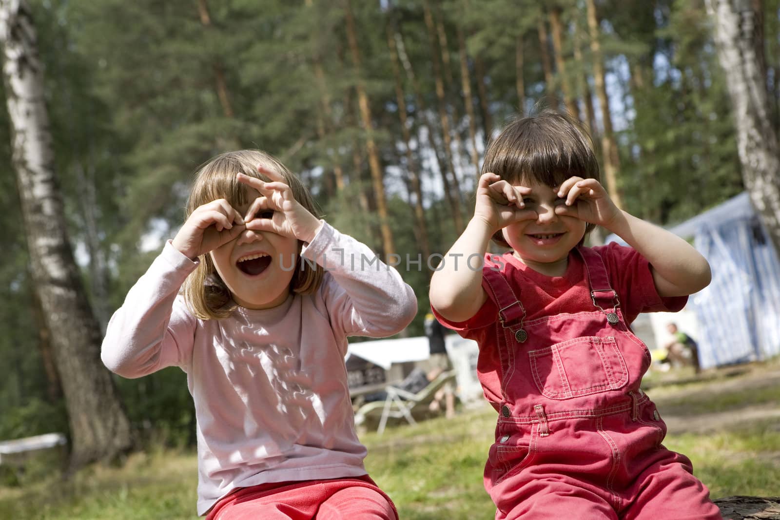 two little cute smiling girl sitting and close eyes. Summer time by elenarostunova