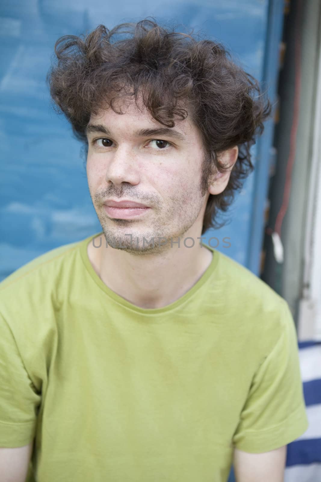 portrait young curl attractive man wearing green t-shirt by elenarostunova