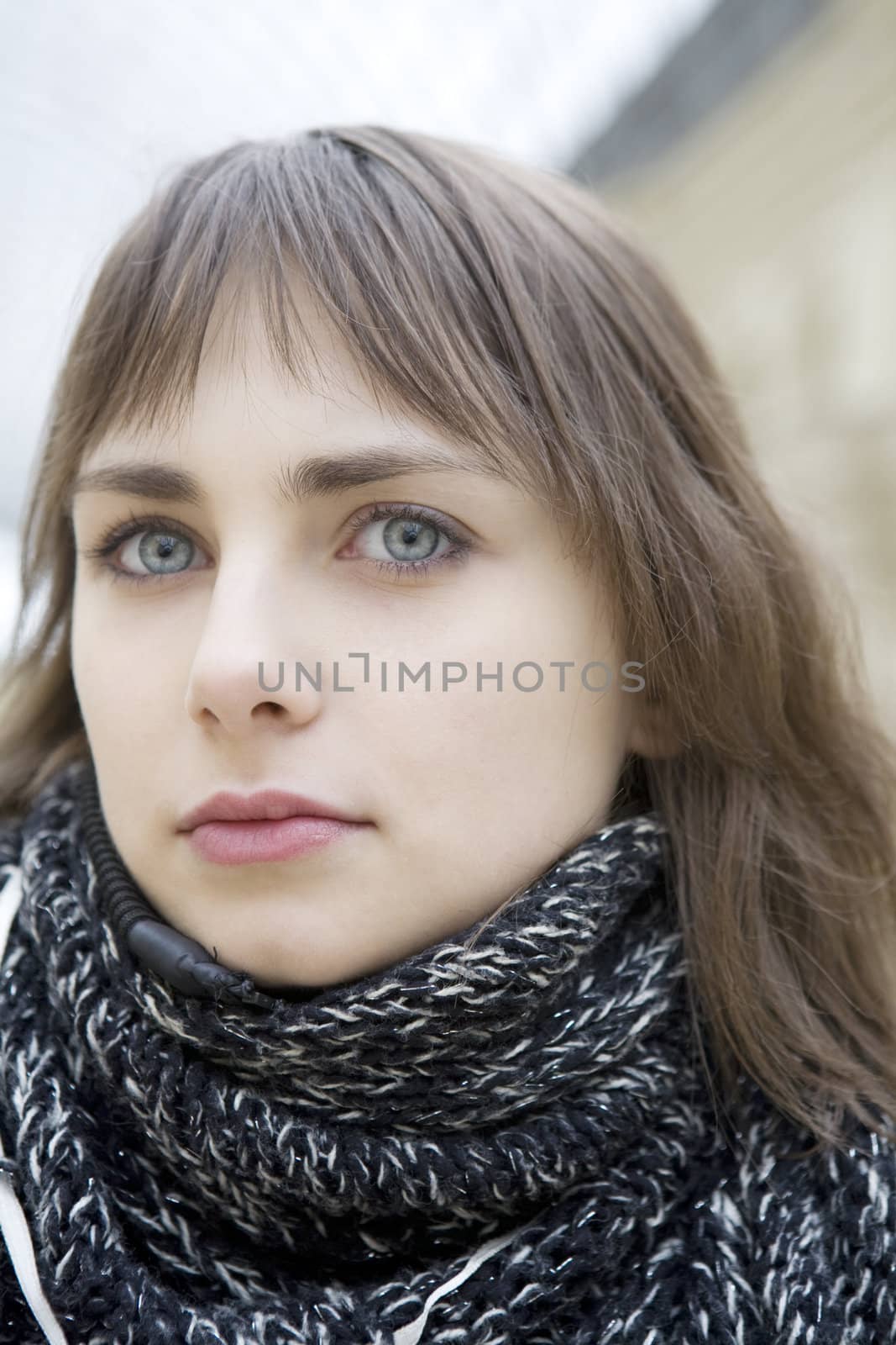 closeup portrait of young serious attractive  woman with green eyes