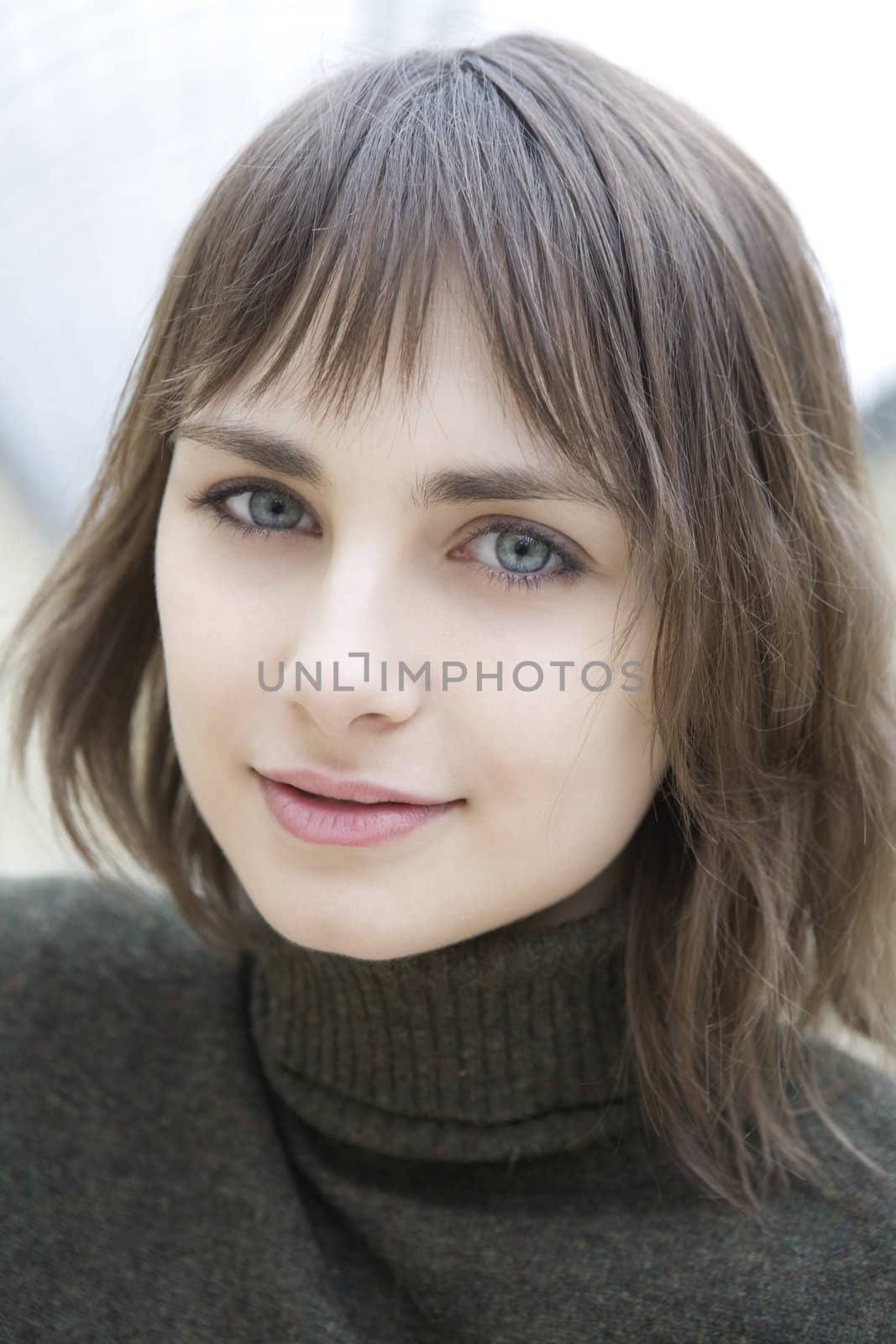 closeup portrait of young serious attractive red hair woman with green eyes