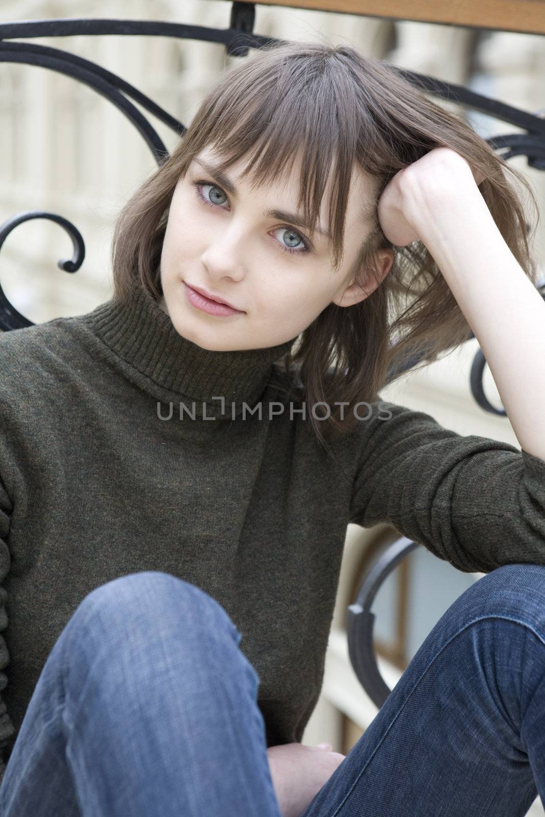 portrait of young serious attractive woman with blue eyes by elenarostunova