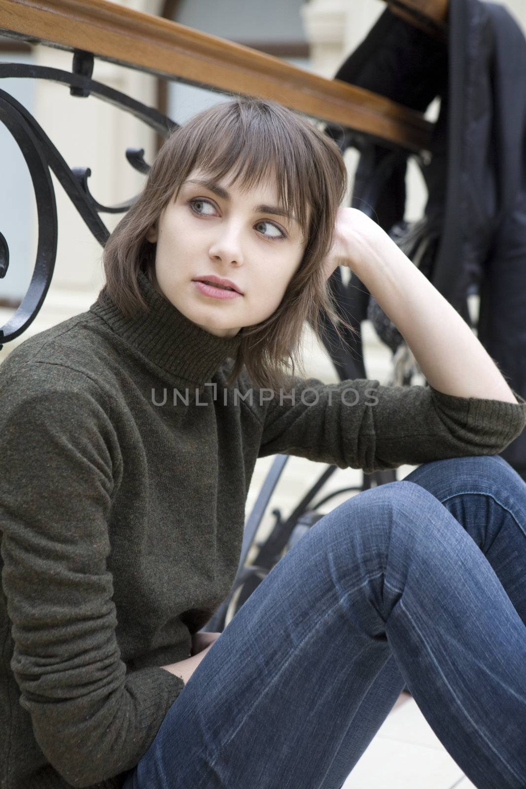 young attractive woman sitting at railing in state department store. Moscow