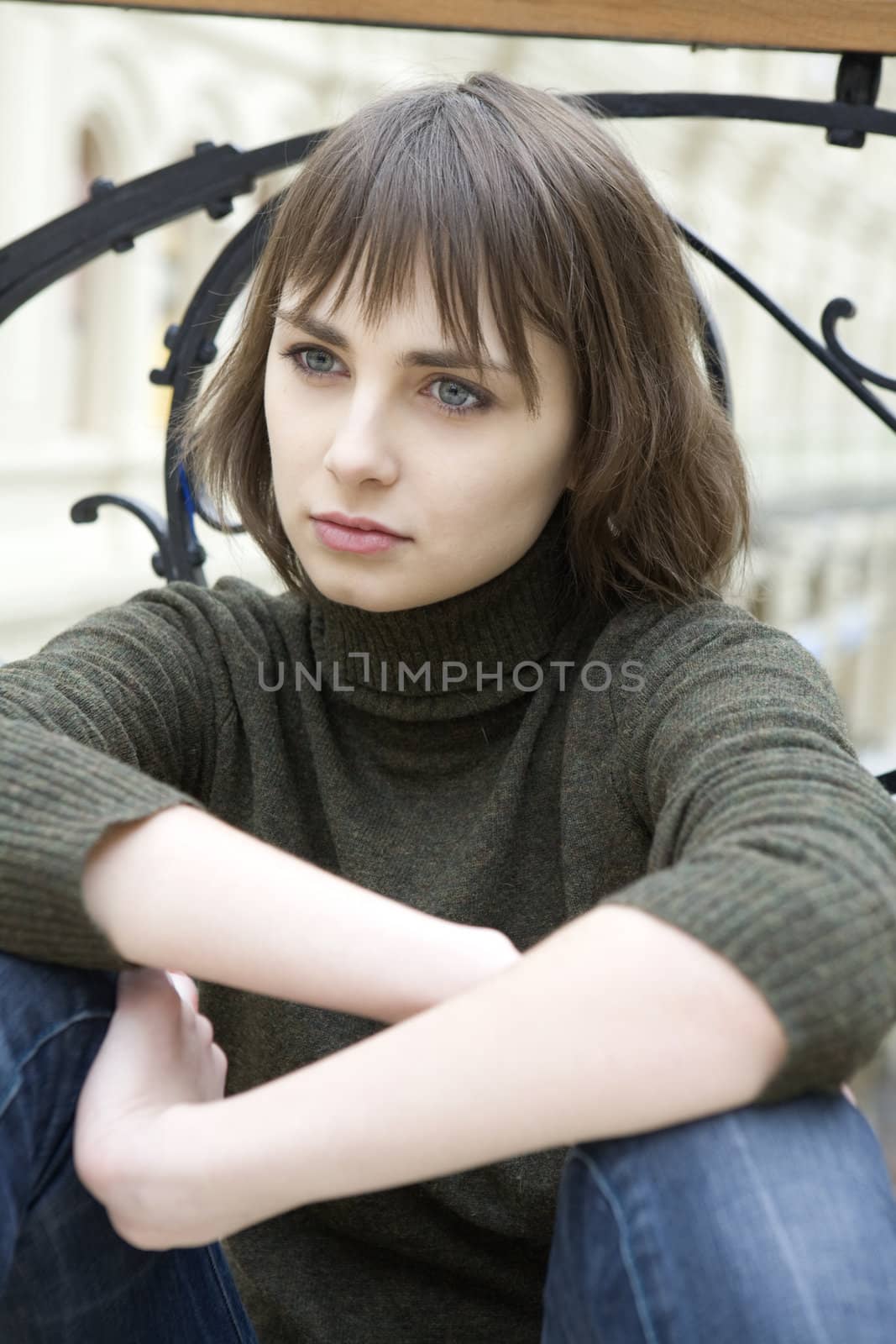 : closeup portrait of young serious attractive  woman with green eyes