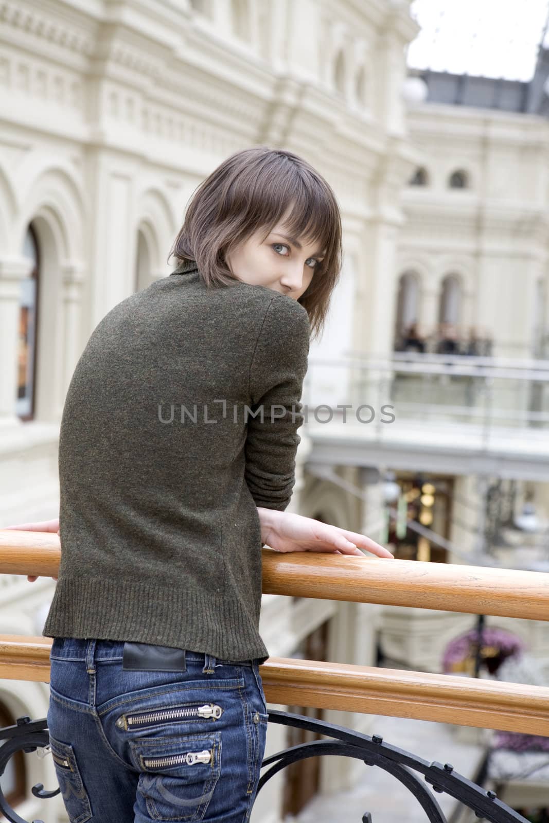 young attractive woman standing at railing in state department s by elenarostunova