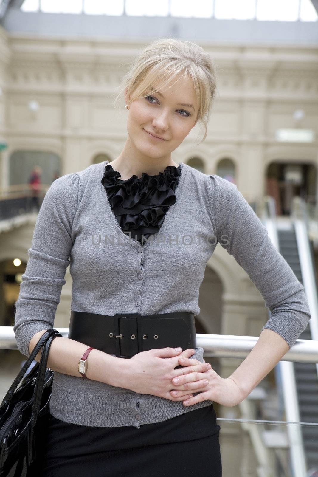 young attractive woman with bag standing at railing in state department store. Moscow