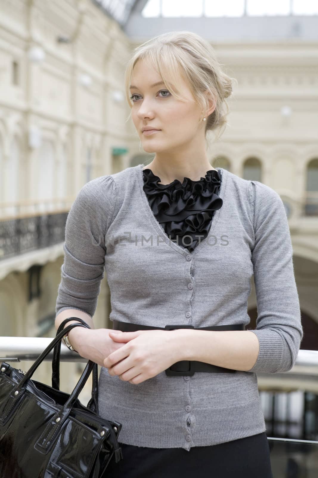 young attractive woman standing at railing in state department store. Moscow