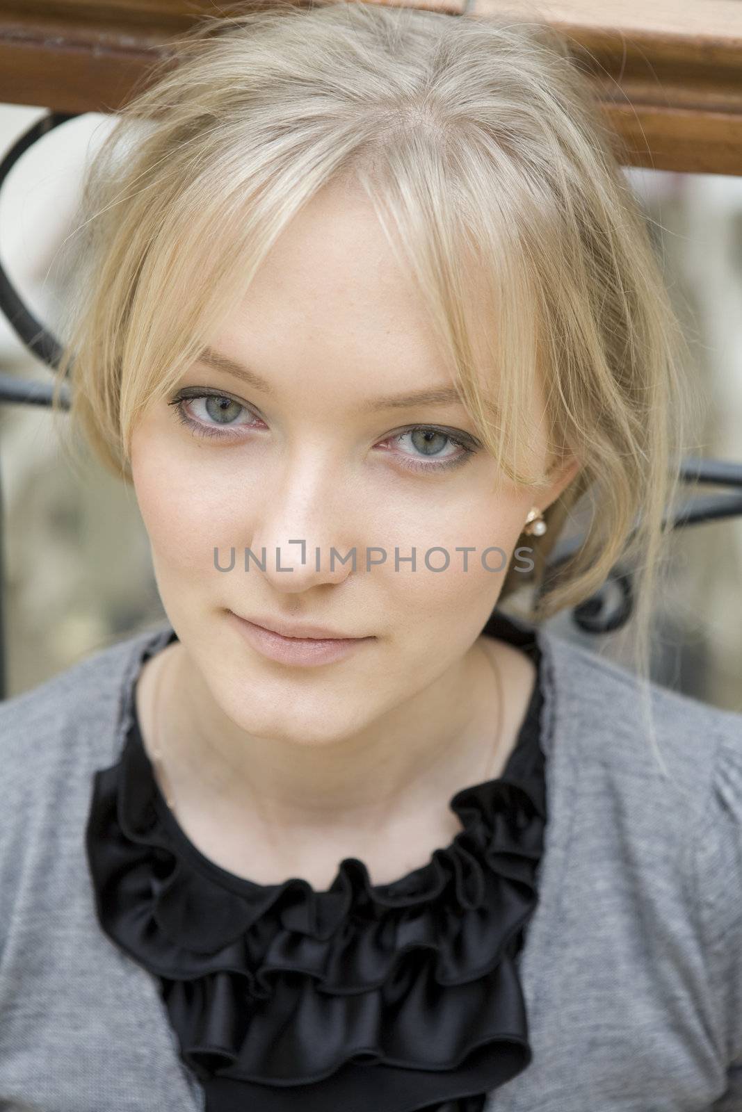 portrait of young serious attractive tired blond woman with blue by elenarostunova