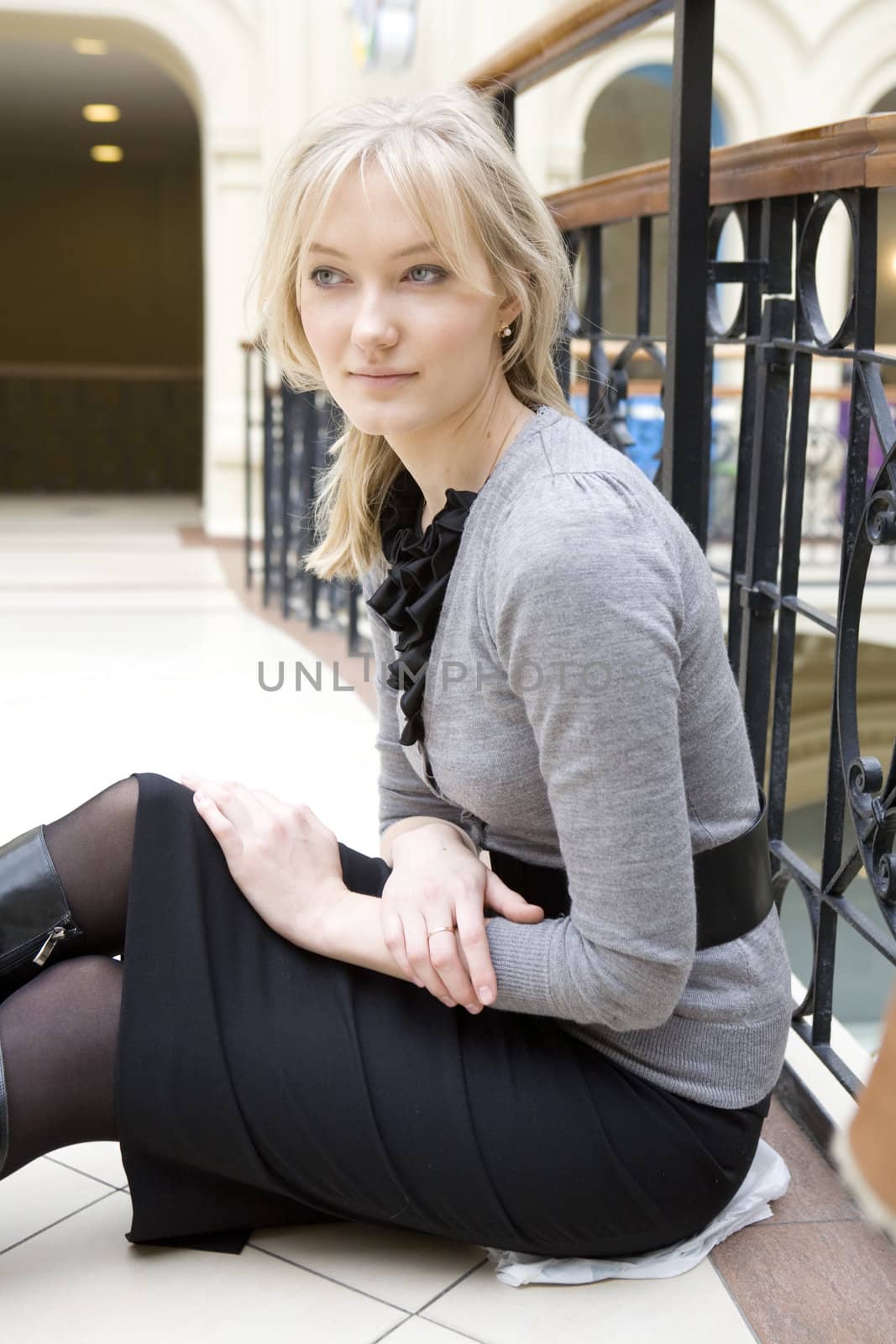 young attractive woman standing at railing in state department store. Moscow
