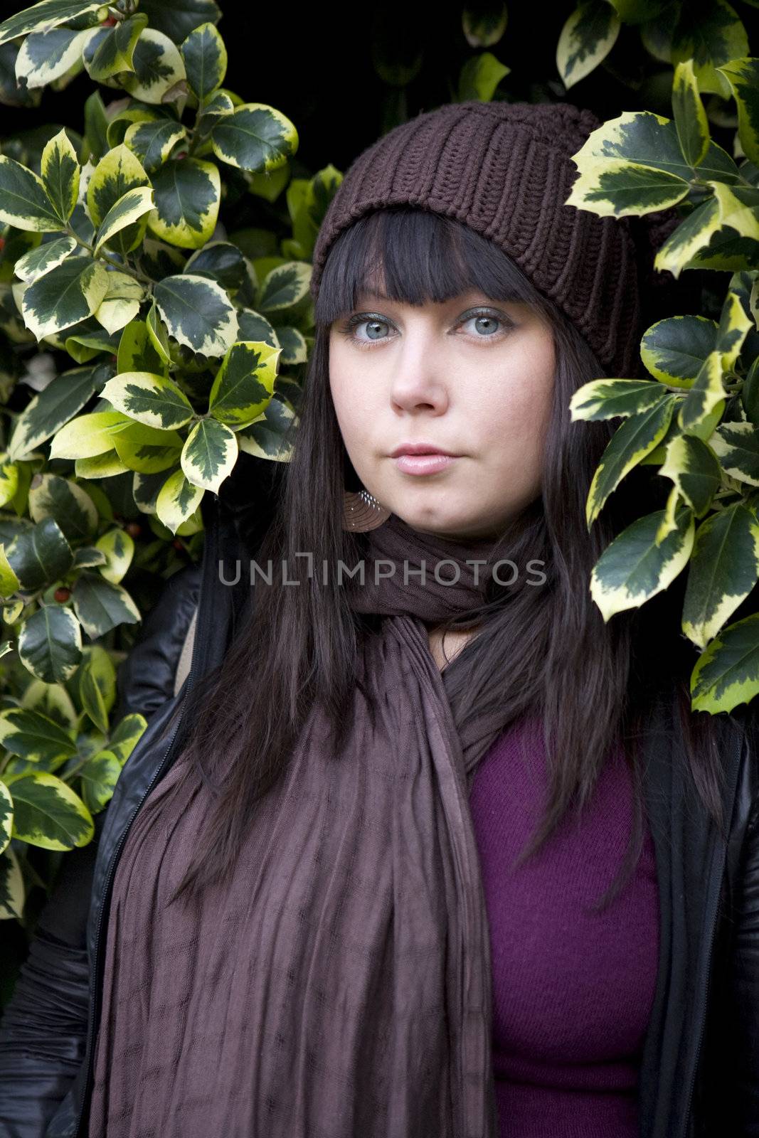 portrait young attractive pensive woman wearing cap standing in bush