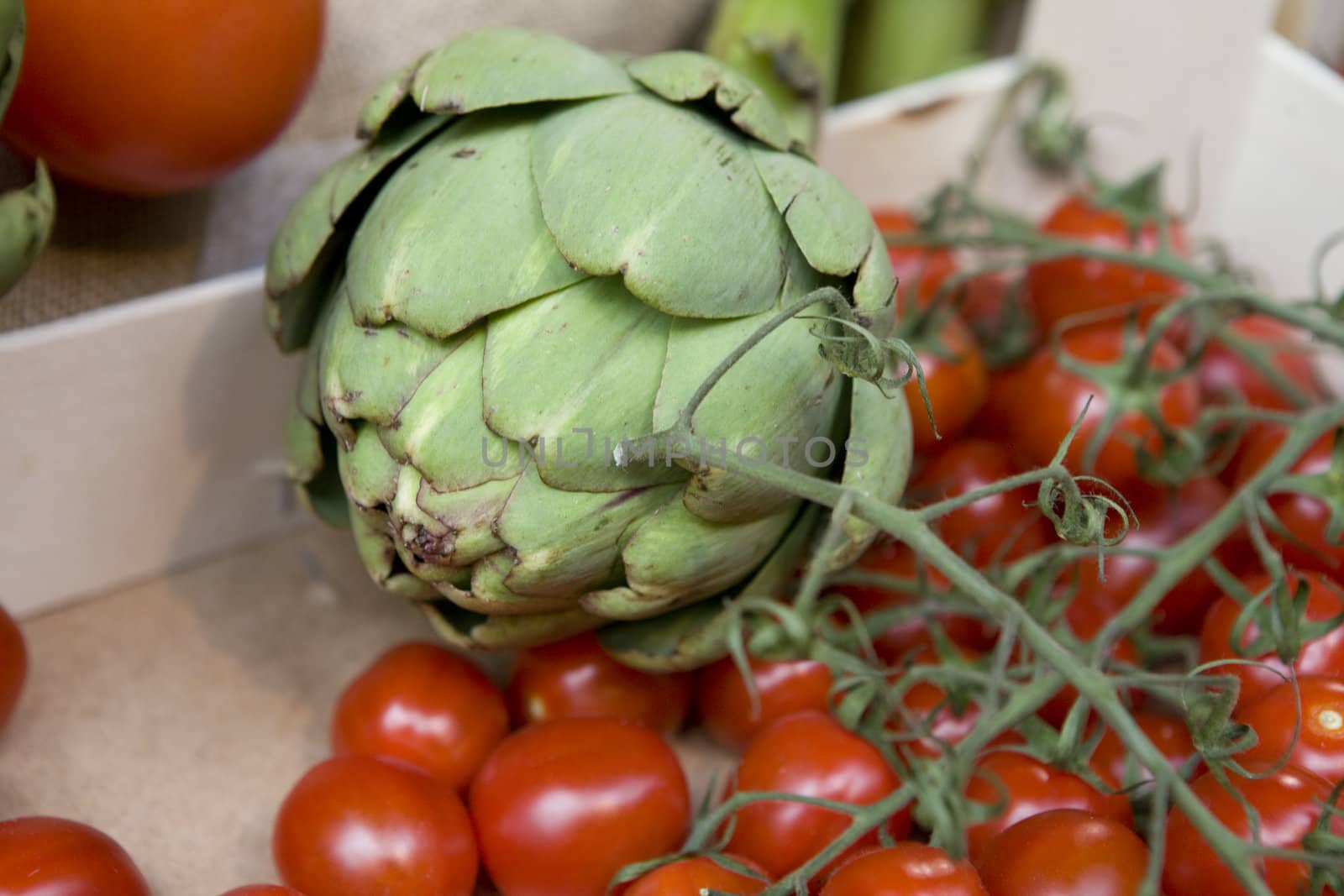 vegetables in grossery shop.  Artichoke and tomato