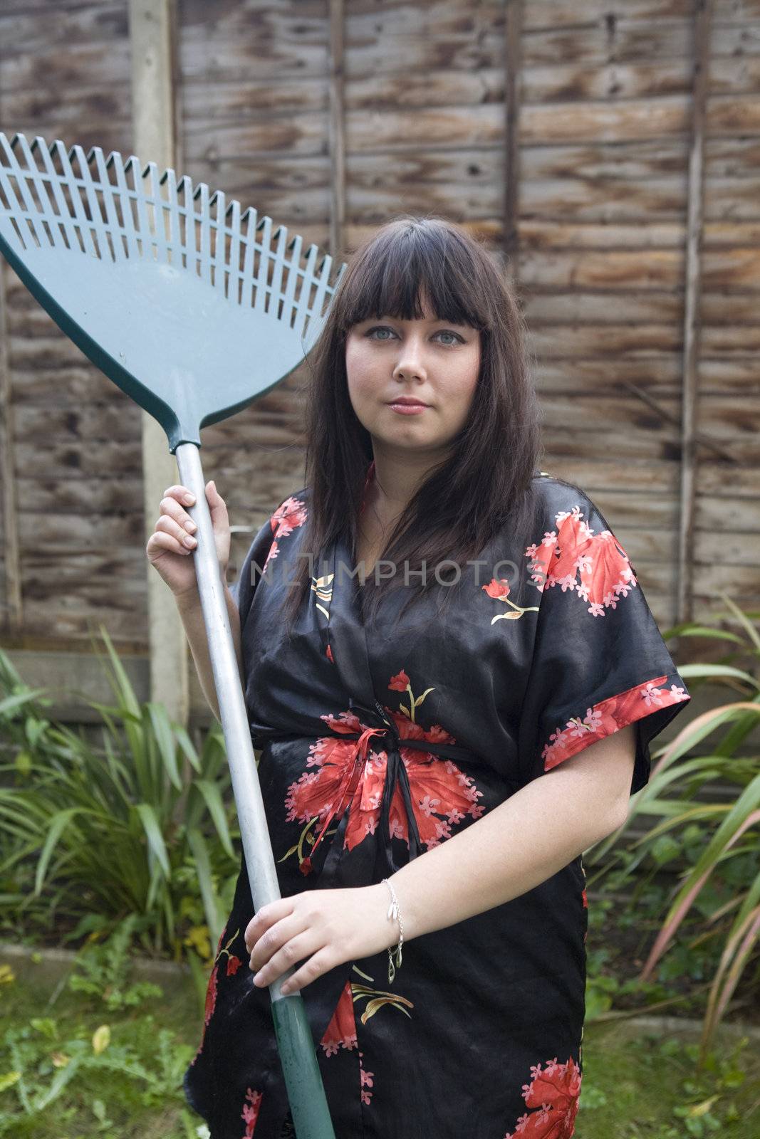 Gardener relaxing holding a rake