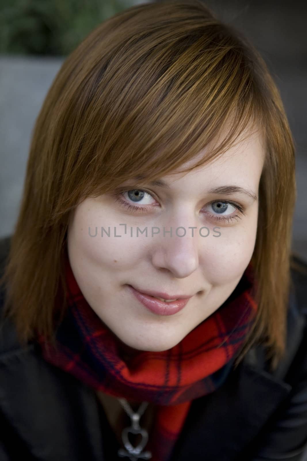 closeup portrait of young serious attractive red hair  woman with blue eyes