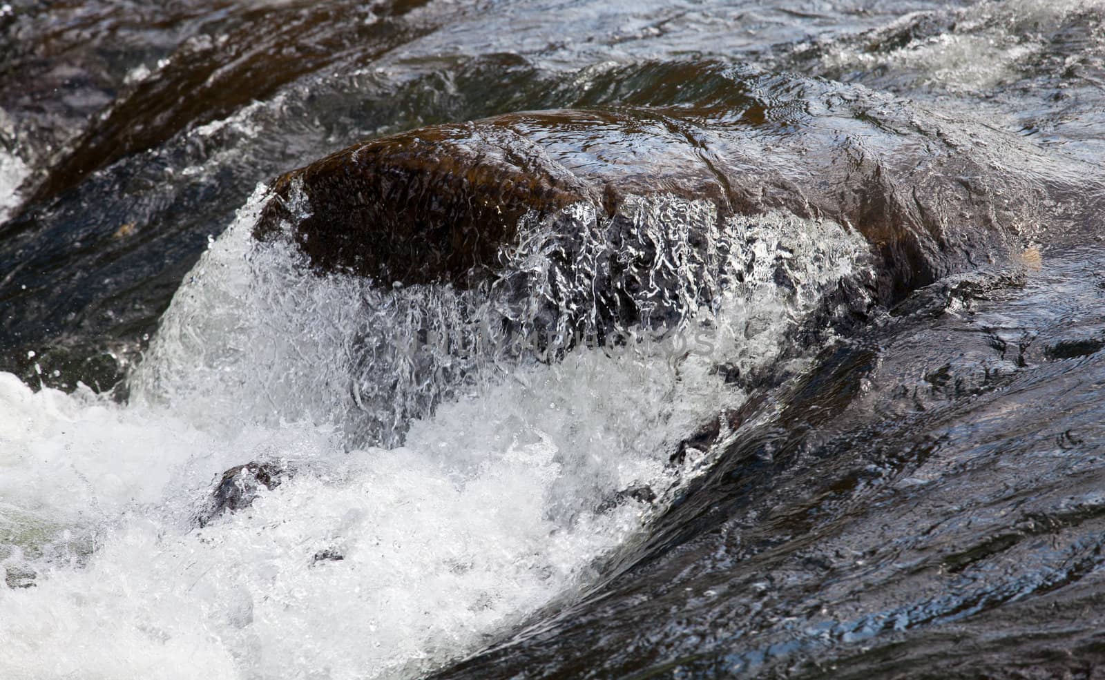 Rushing river over waterfall by steheap