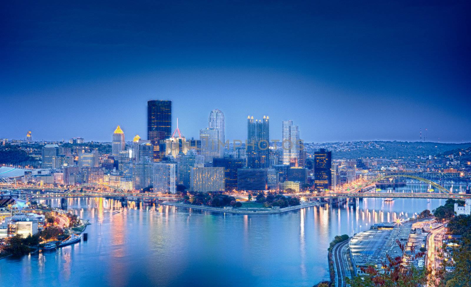 Unusual blue shaded image of Pittsburgh in the evening processed in HDR to highlight the reflections in the river