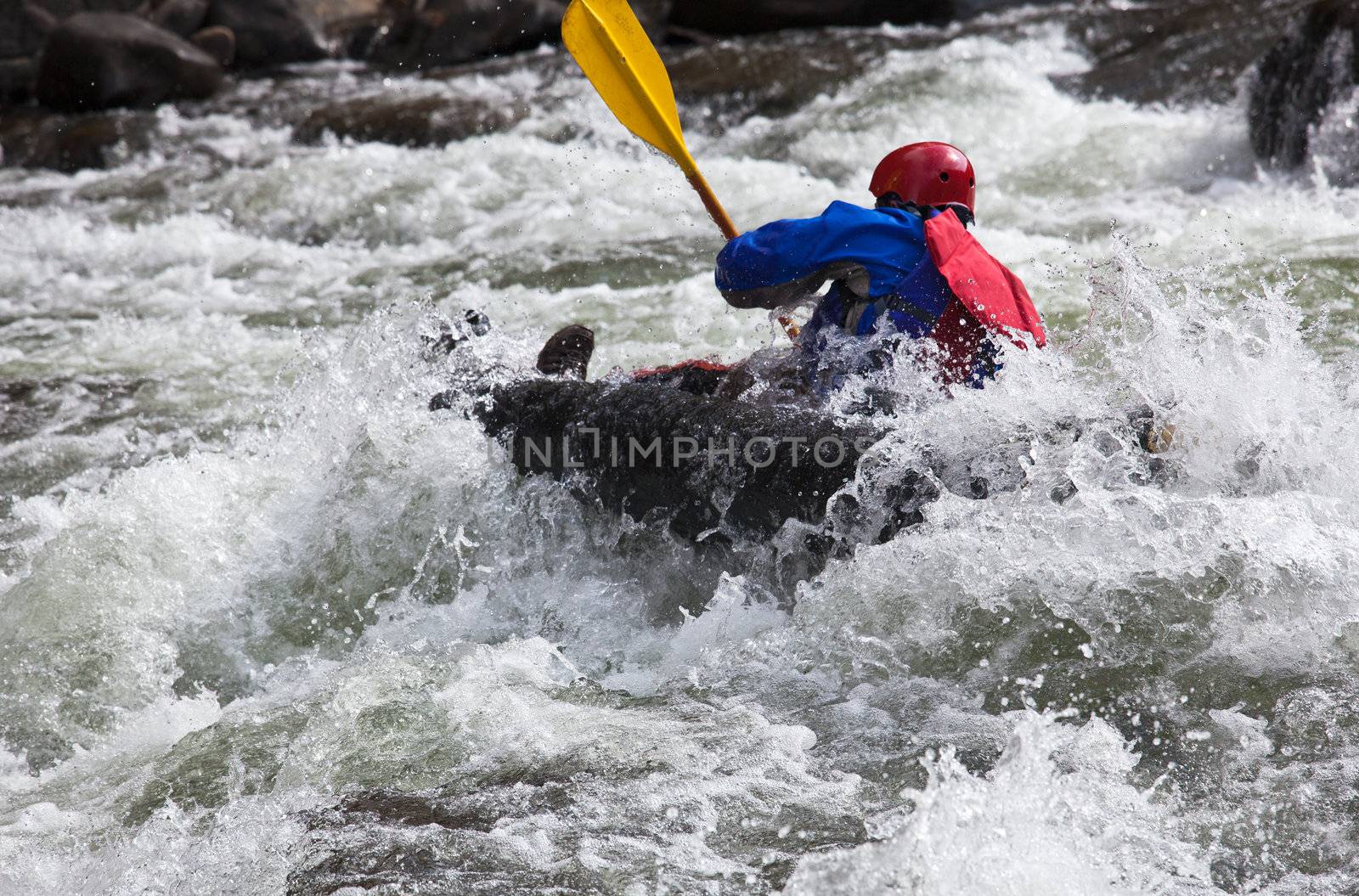 Canoeing in white water in rapids on river