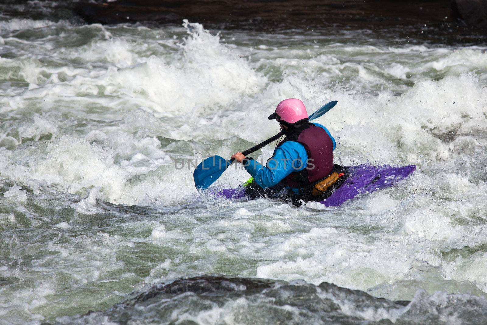 Canoeing in white water in rapids on river