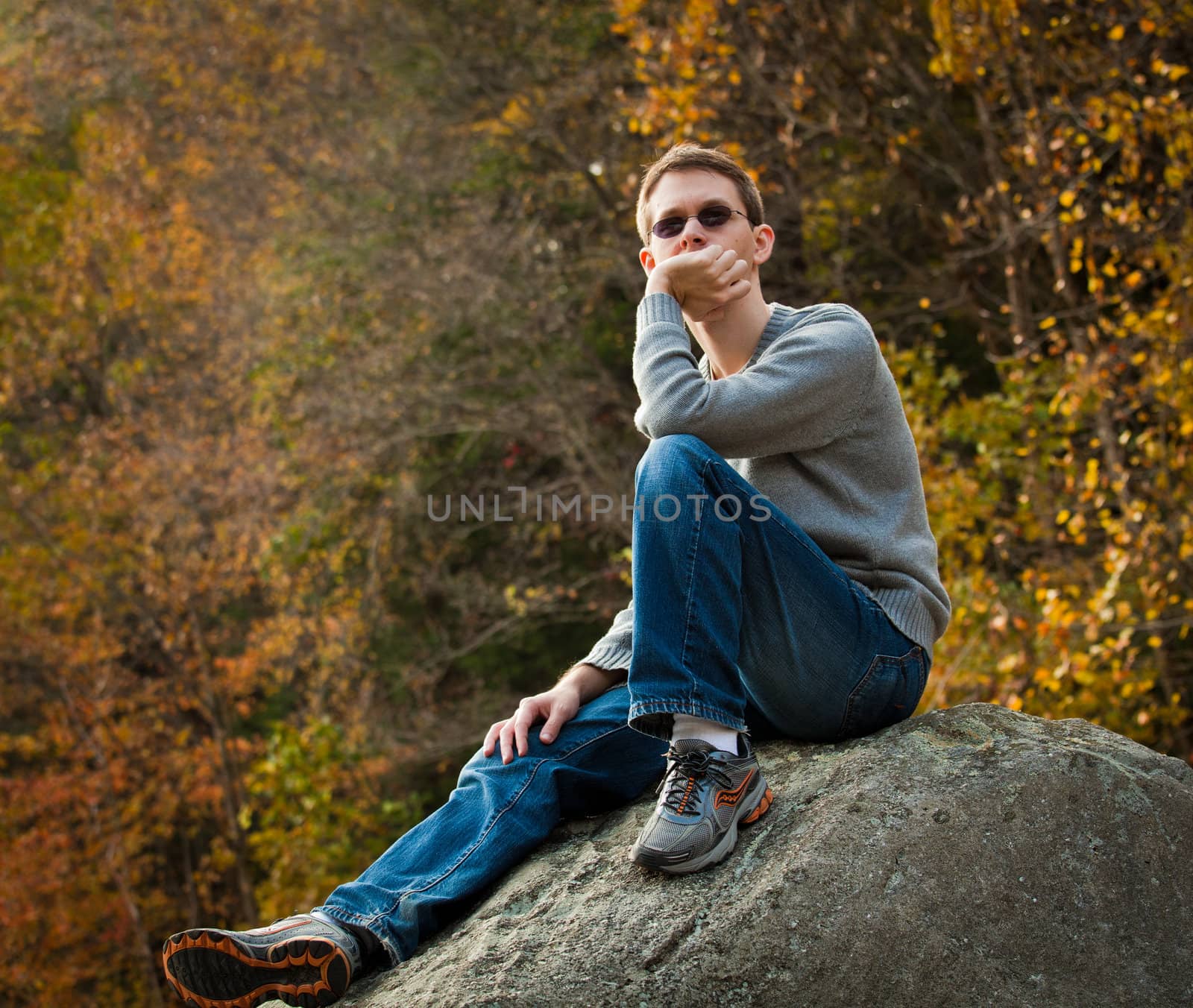Young hiker relaxing on rock by steheap