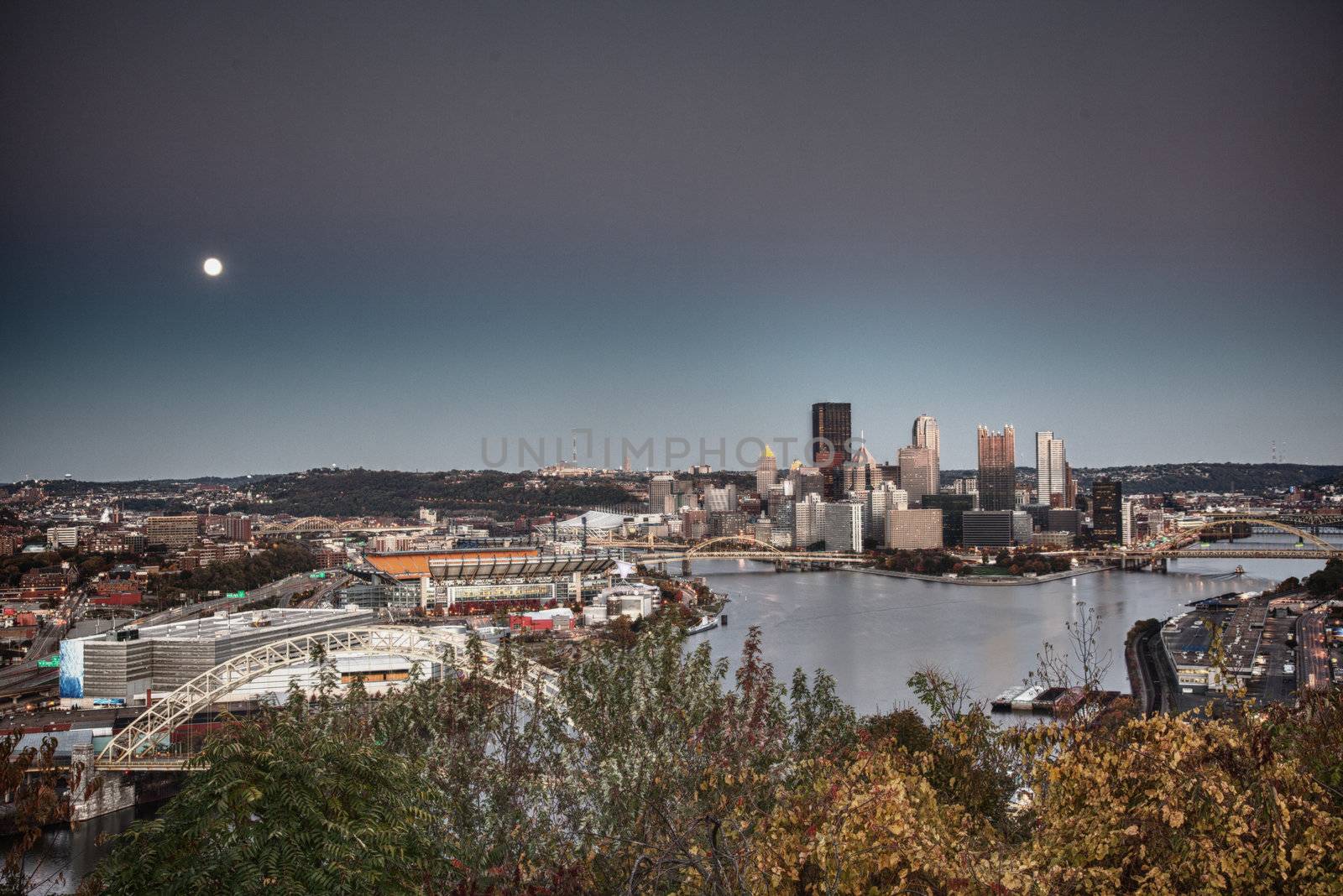 Unusual paint like view of the city of Pittsburgh at sunset as the moon rises over the horizon