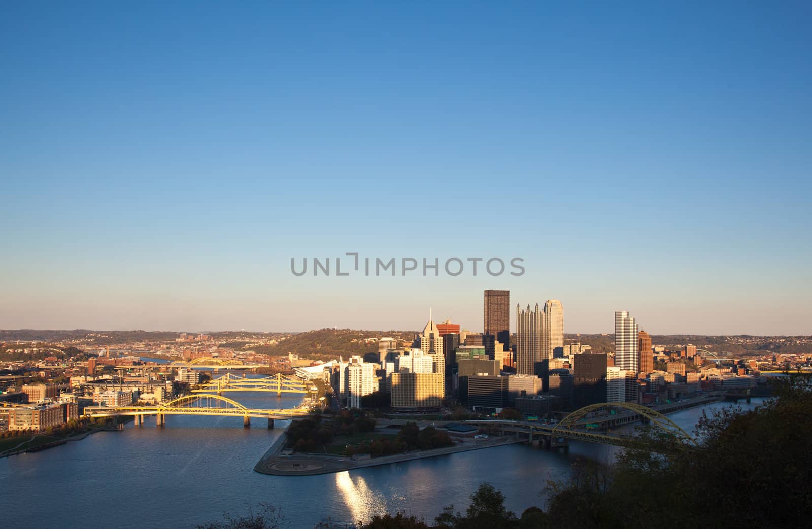 Setting sun highlights the tops of the tall buildings in downtown Pittsburgh