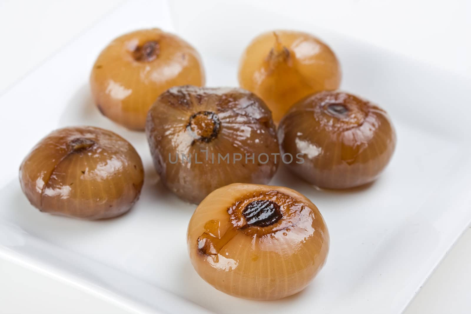 pickeled onions on a white plate by bernjuer