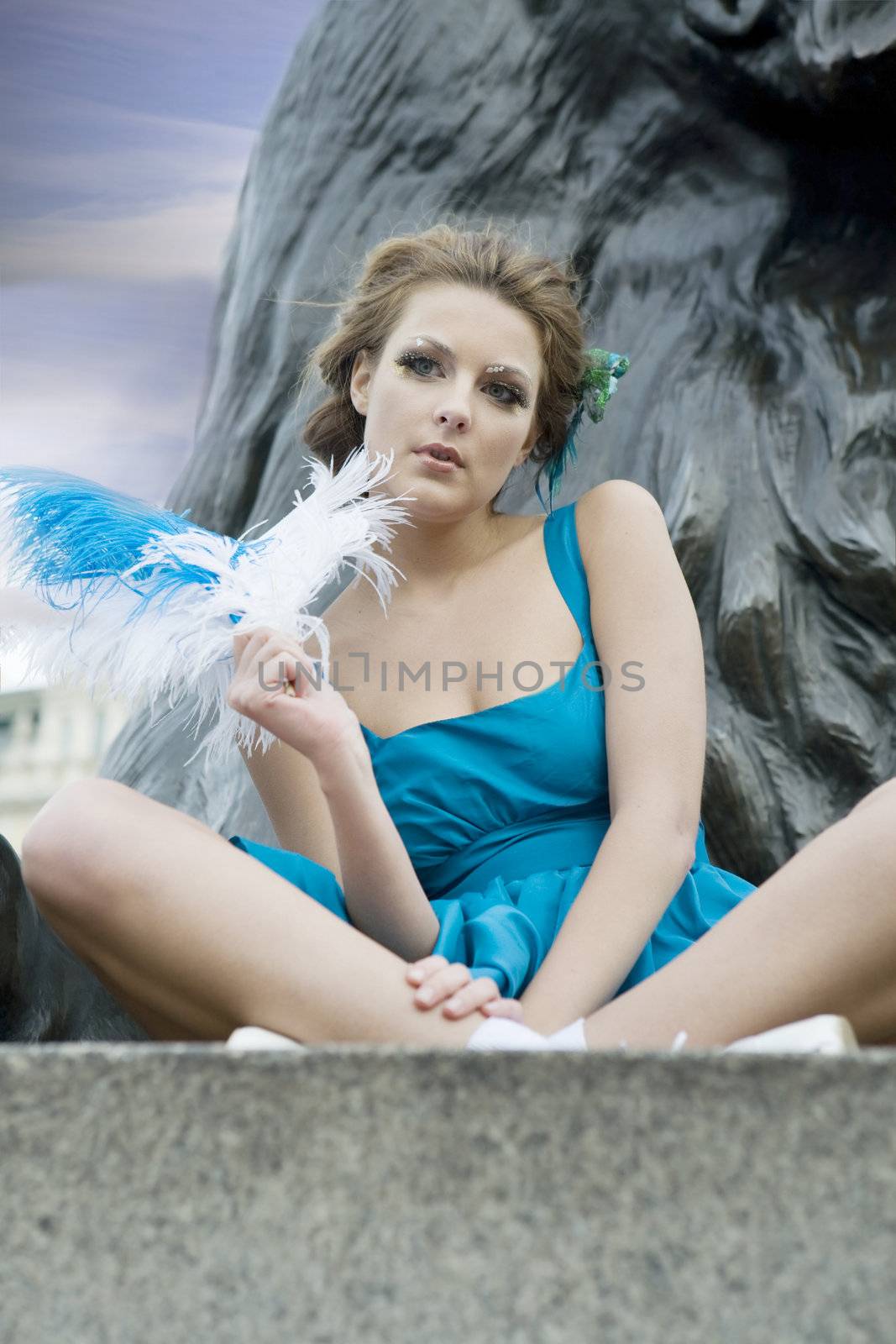 young adult girl sitting at Trafalgar Square. London