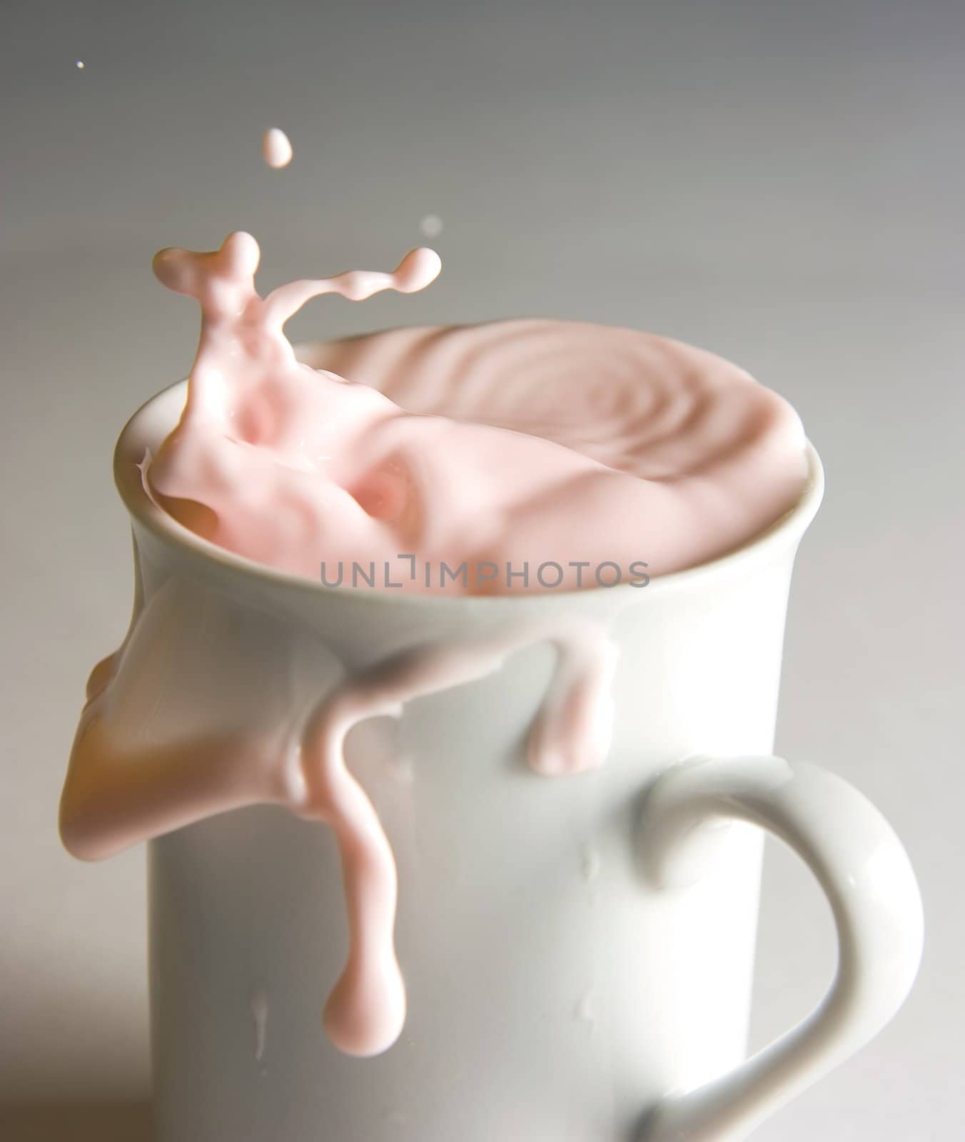 White cup with a lapping dairy drink