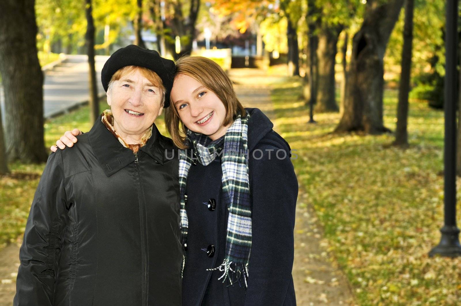 Granddaughter walking with grandmother by elenathewise