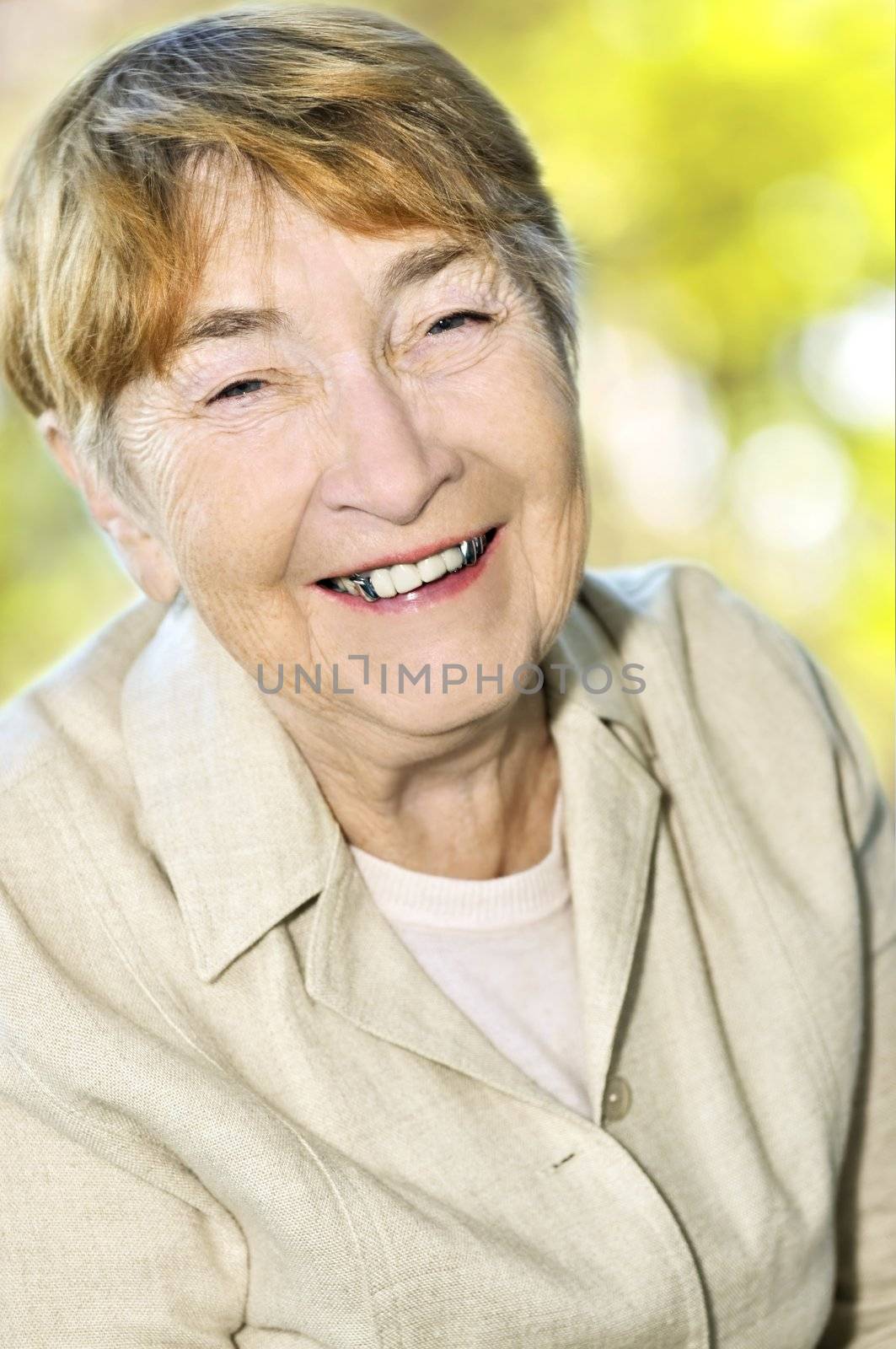 Senior woman laughing and smiling with abstract background