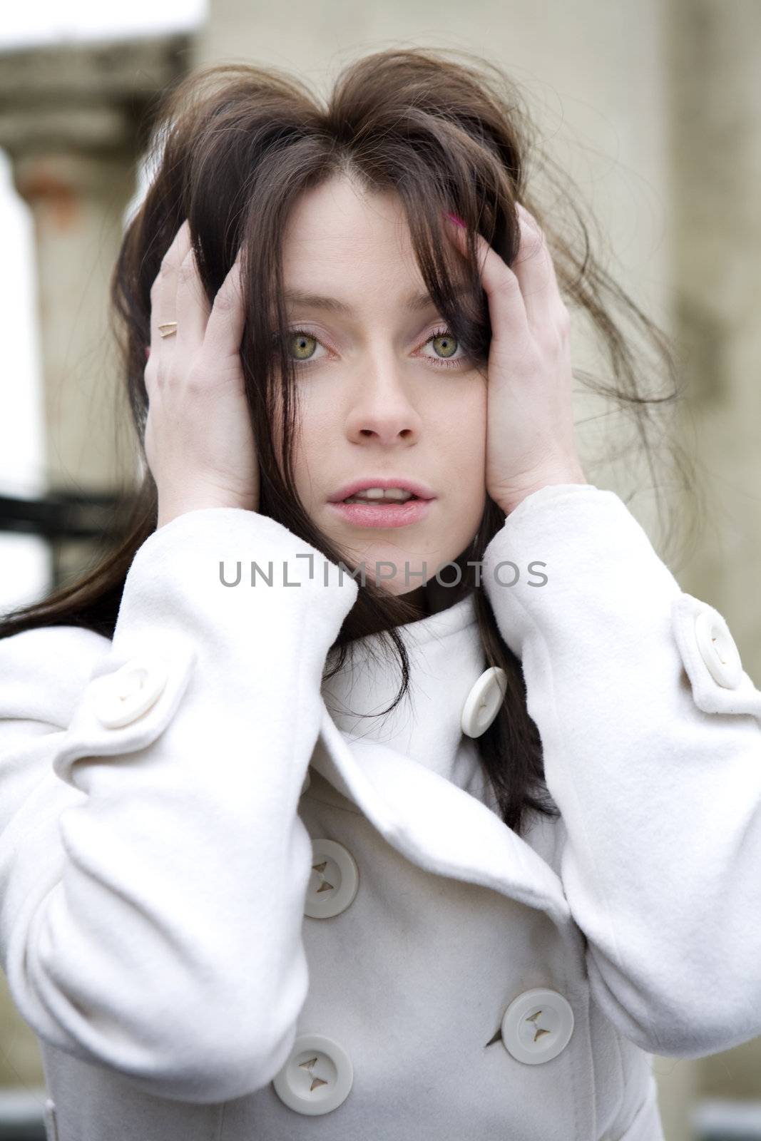 portrait of surprised young adorable woman wearing white coat