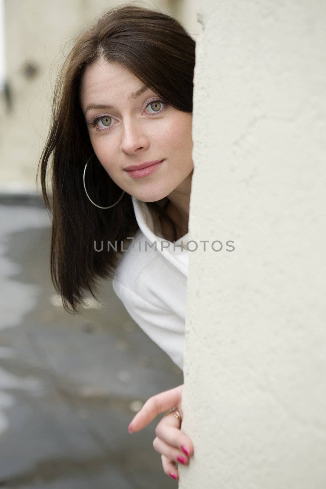 portrait of surprised young adorable woman wearing white coat