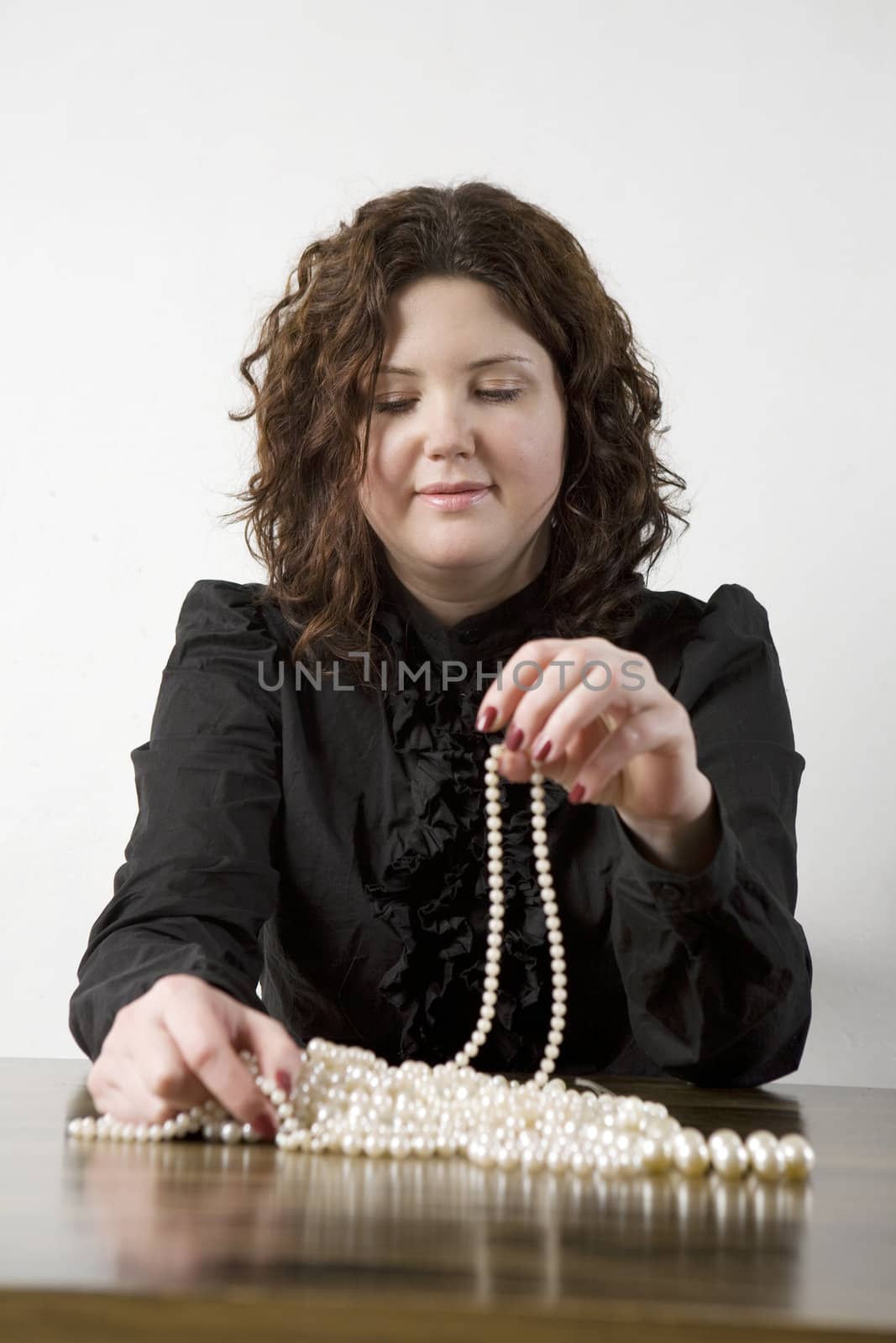 portrait young attractive woman count one's beads by elenarostunova