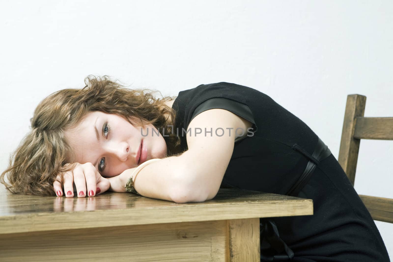 upset girl put her head down table. Woman`s problem.