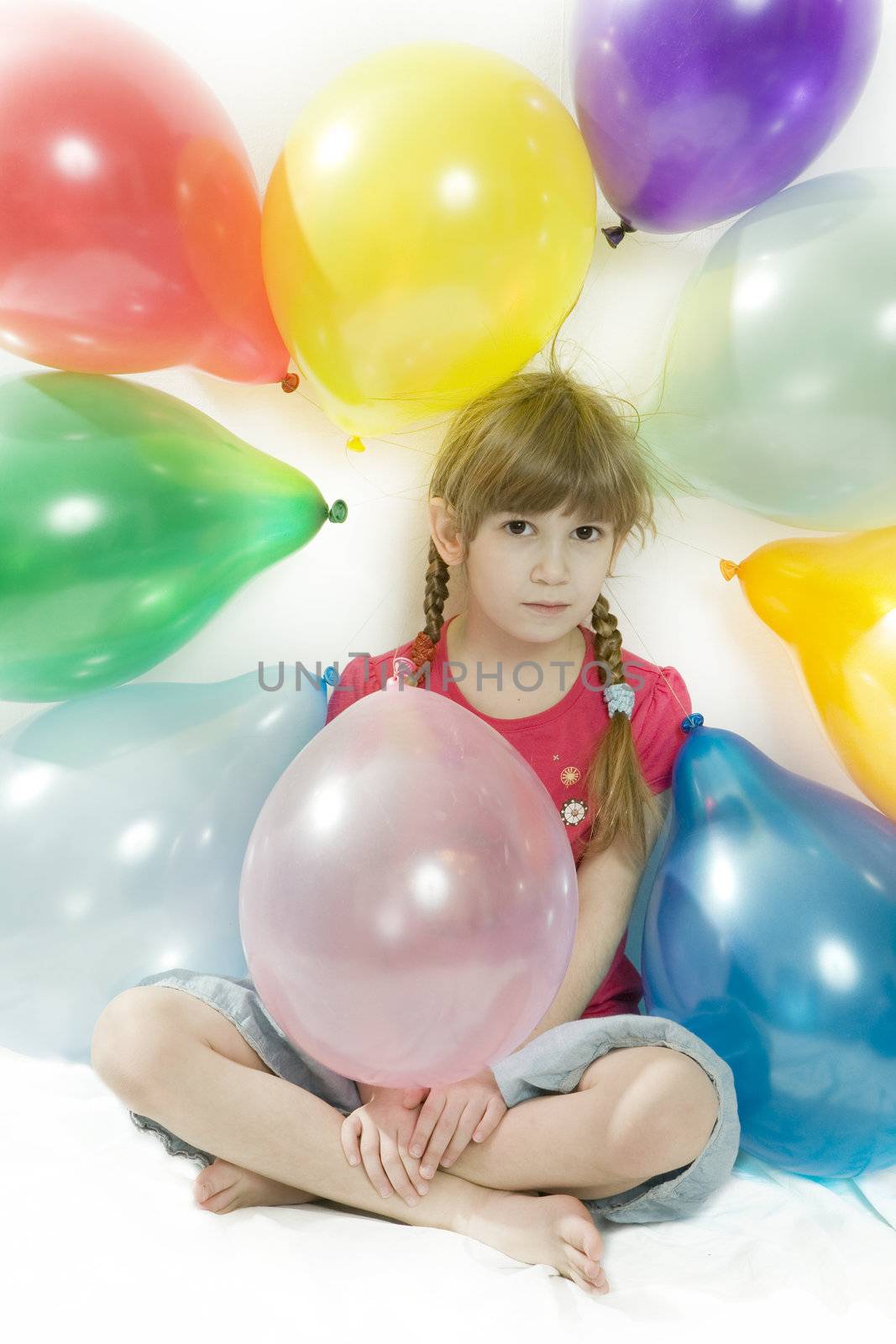 little happy giggle girl sitting with colour balloons. Girl celebrated her birthday. Isolated