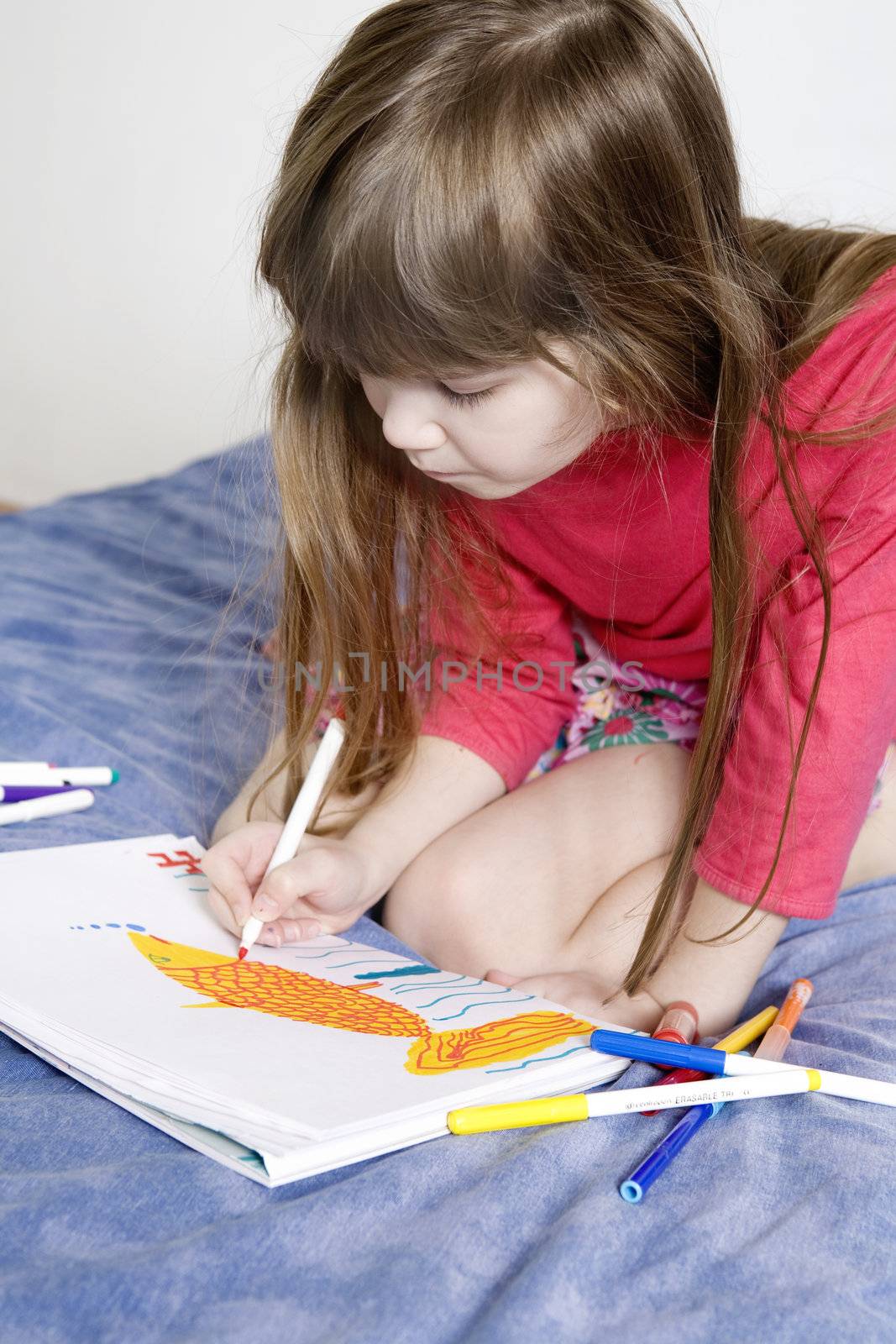 little cute smiling girl seven years old with drawing picture