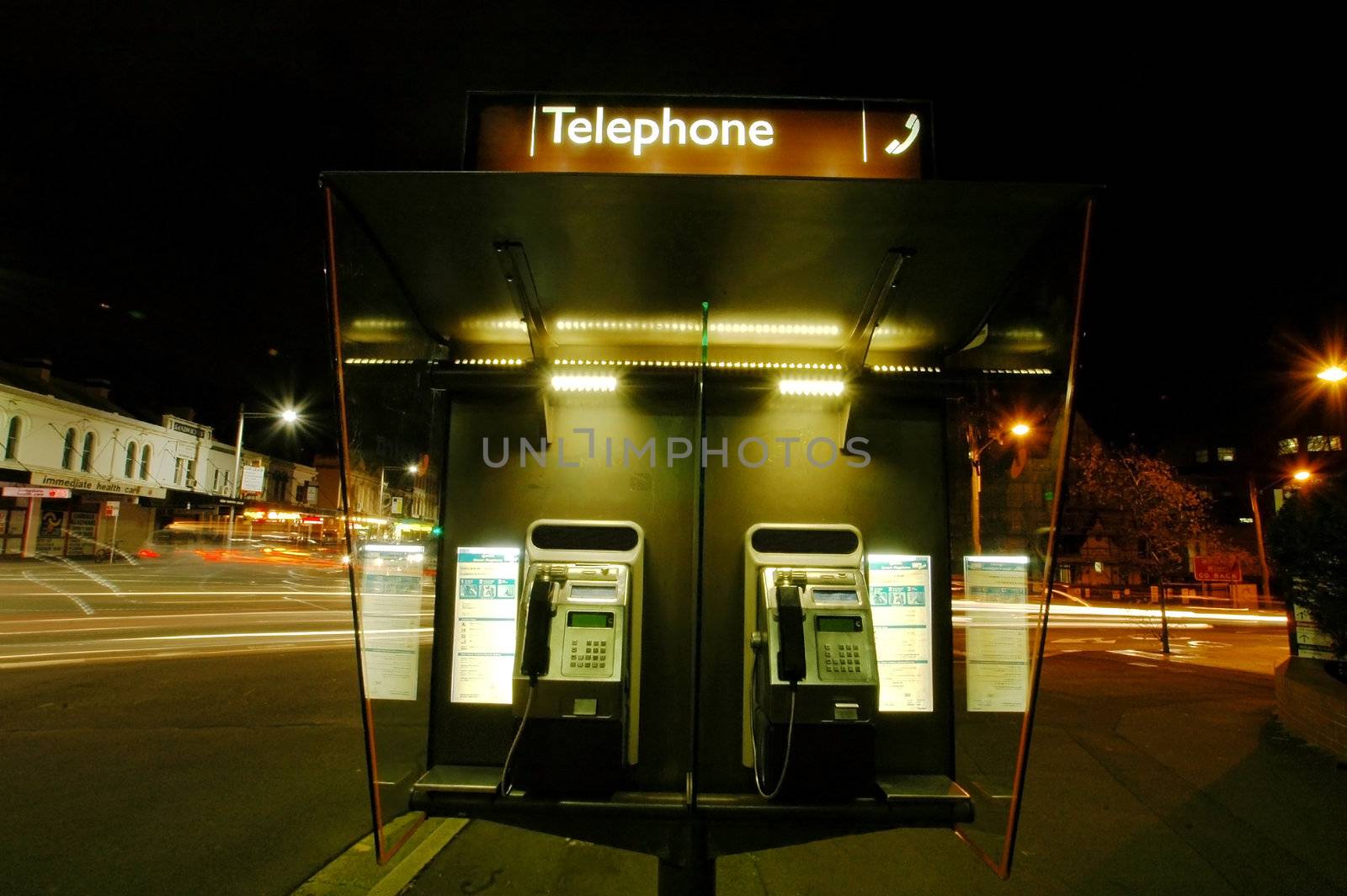 night scene, telephone booth, lights from moving cars