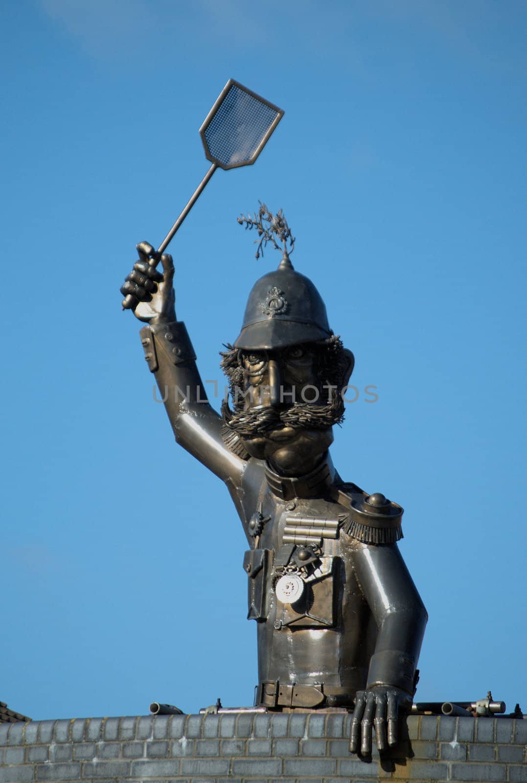 Policeman statue with fly swatter